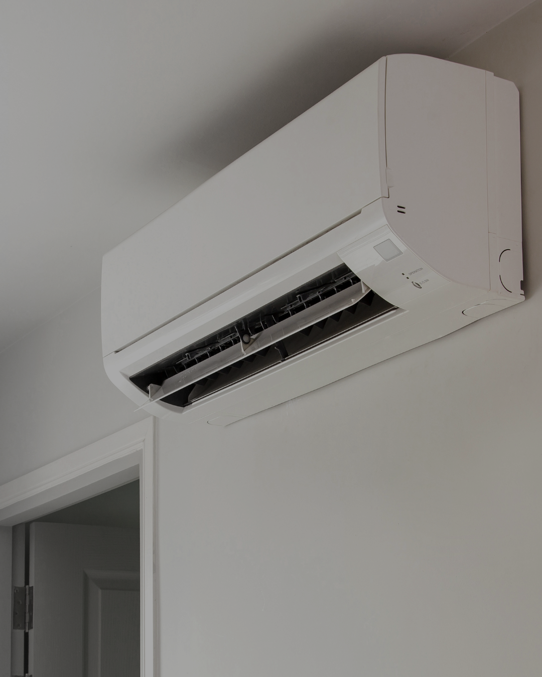 A white wall-mounted split air conditioning unit.