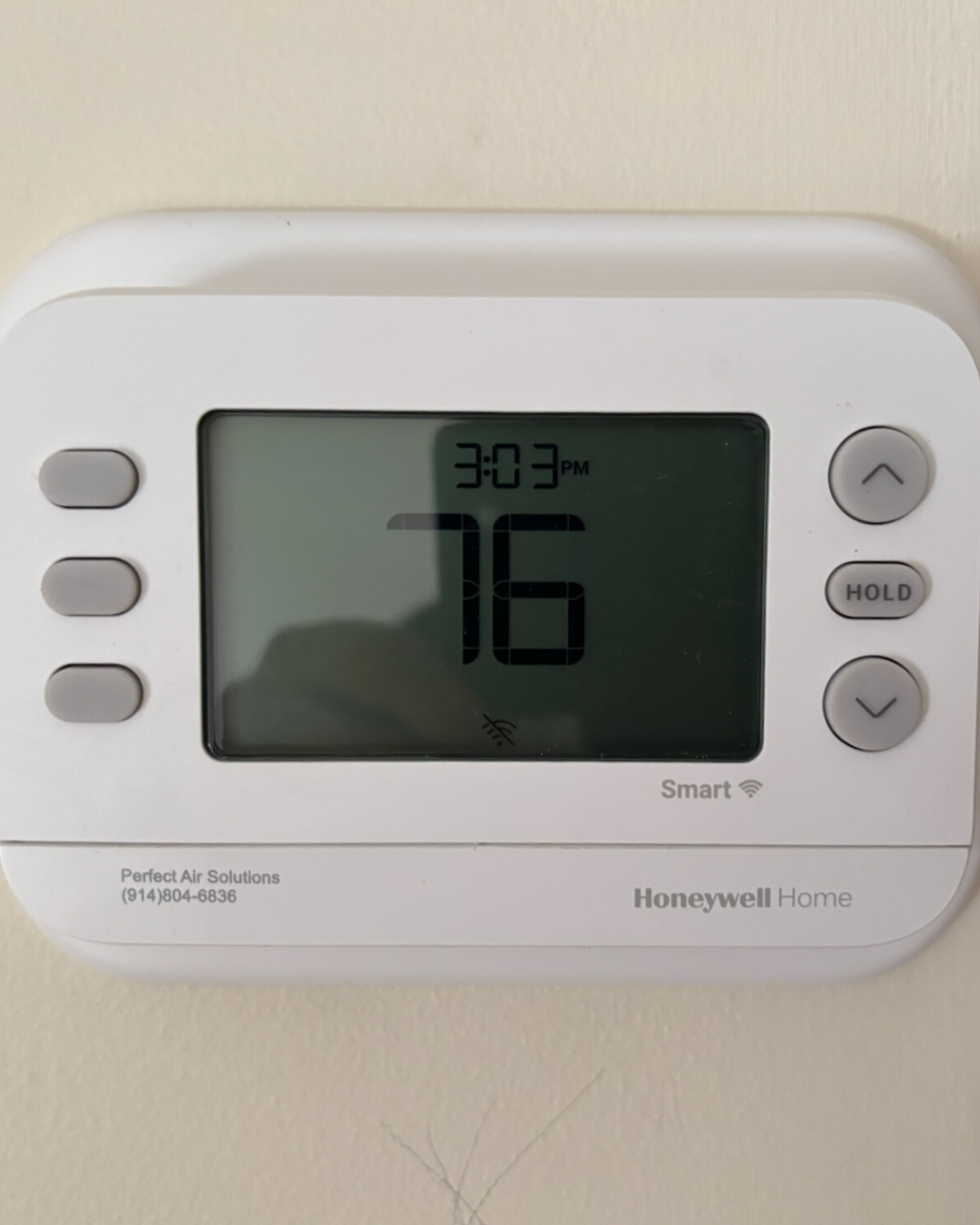 Digital thermostat displaying 16 degrees Fahrenheit, 3:03 PM, with buttons on the side.