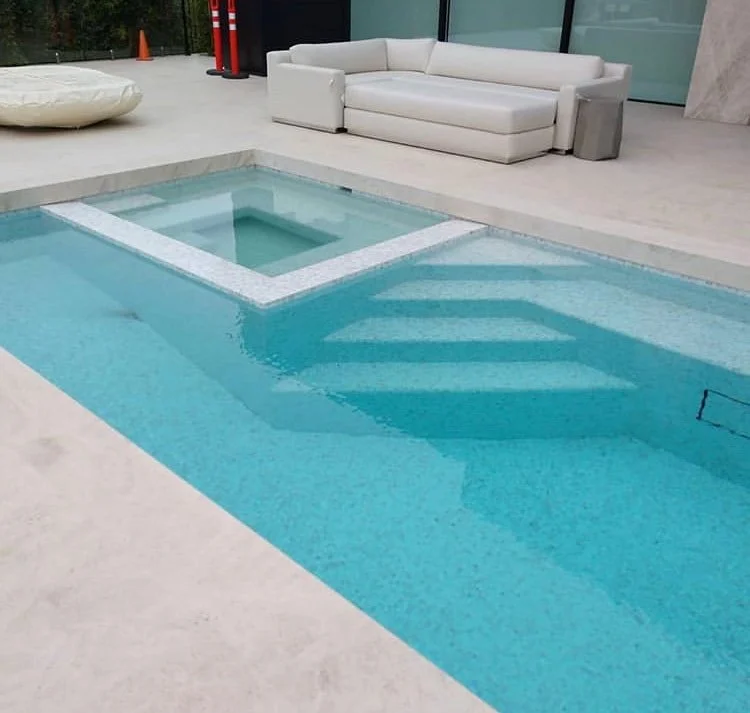 Inspired by modern European resorts, this sleek pool offers clean lines, generous seating, and a bright, inviting outdoor atmosphere ideal for entertaining.
