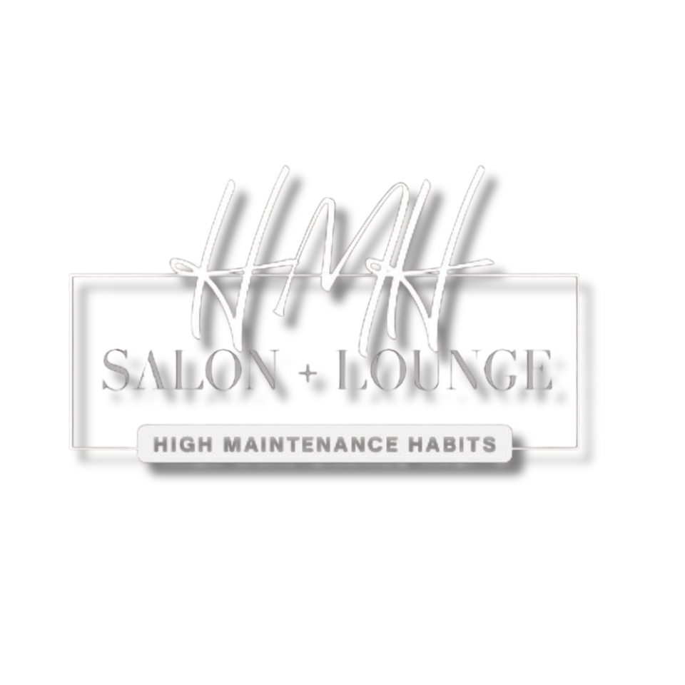 Neon sign for HMH Salon + Lounge with the tagline "High Maintenance Habits" on a black background.