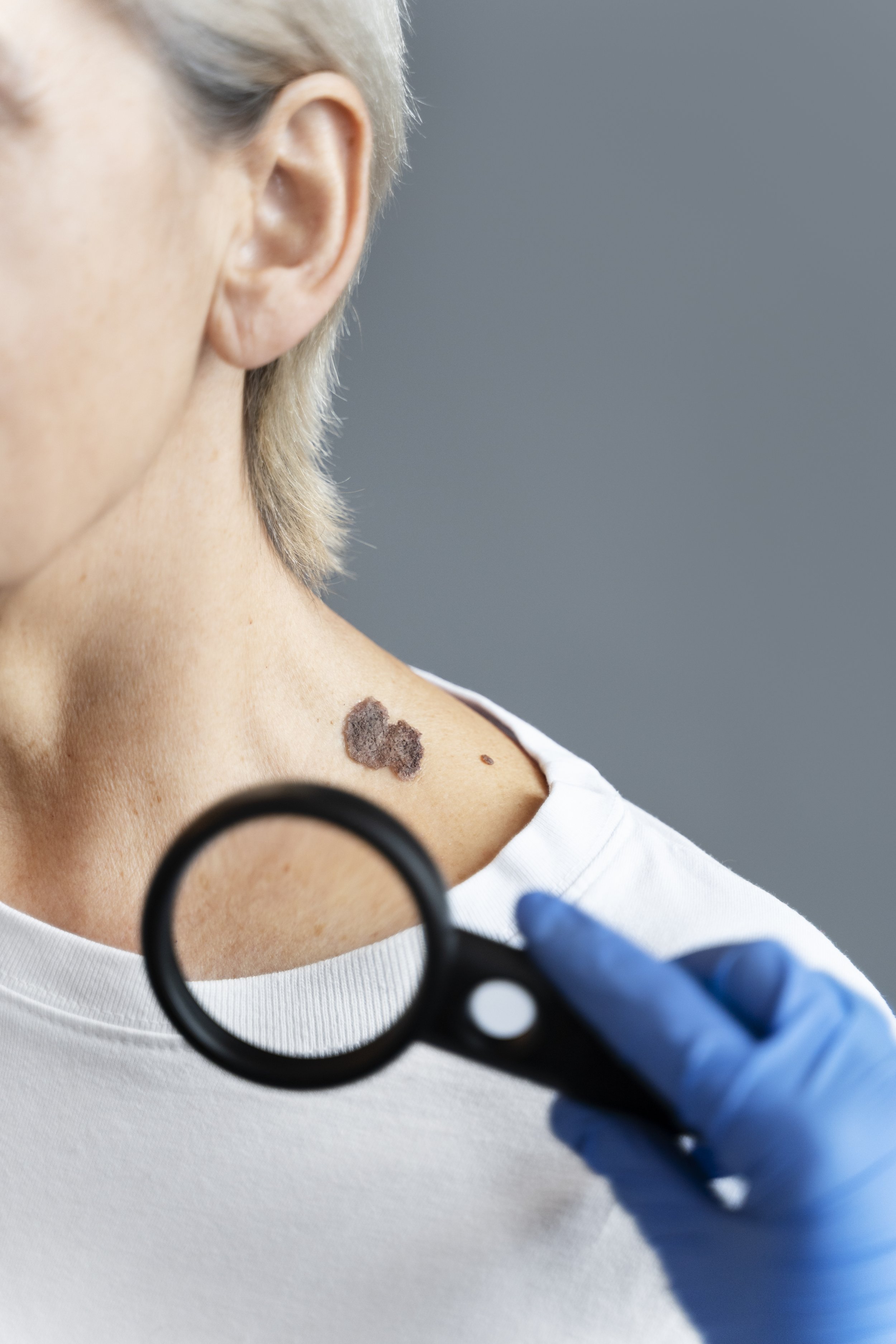 hand-with-glove-holding-magnifying-glass