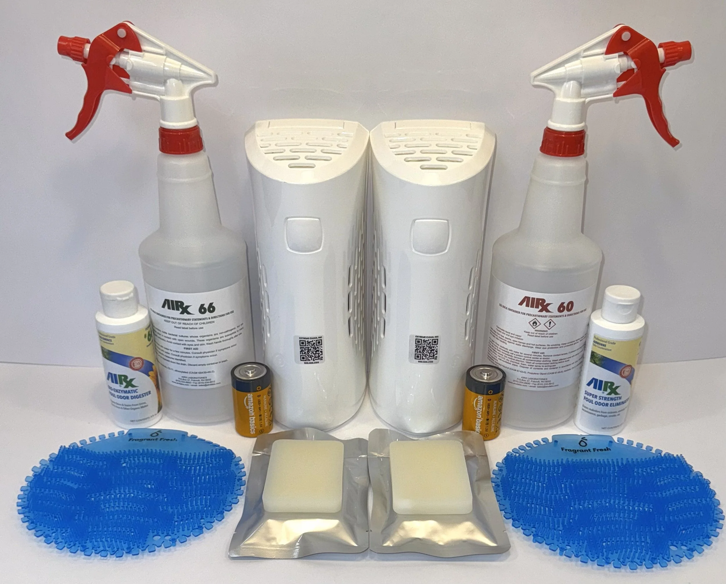 Cleaning supplies including spray bottles labeled AIRX 66, two blue microfiber cloths, two white soap bars in silver wrappers, two small bottles of AIRX disinfectant, two AA batteries, and other cleaning products arranged on a white surface.
