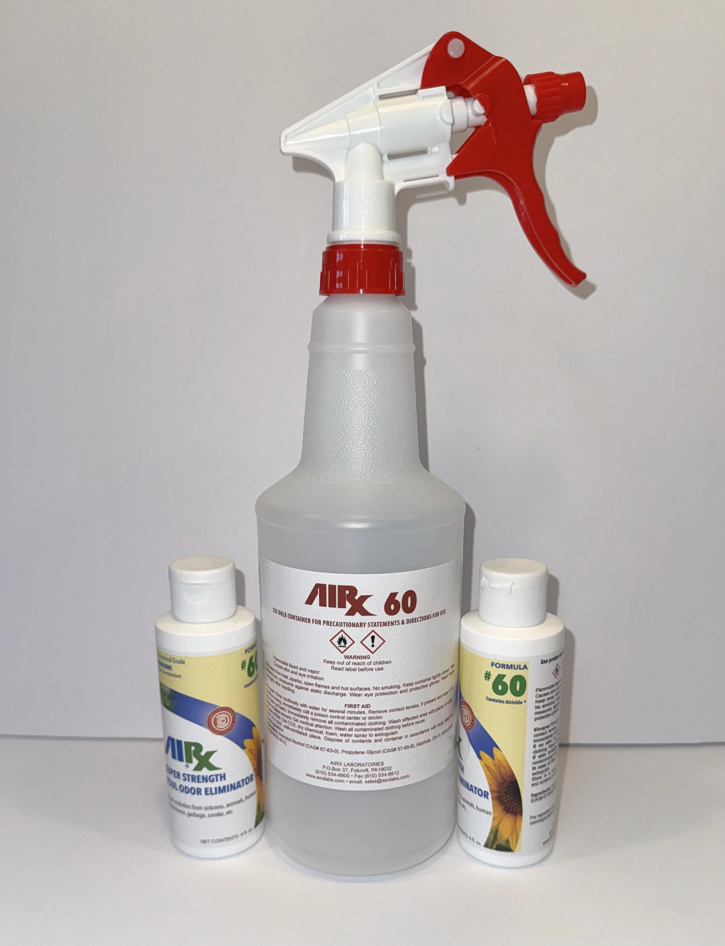 A spray bottle labeled 'AIRX 60' surrounded by two smaller bottles of AIRX odor eliminator, with red and white spray nozzles and a plain white background.