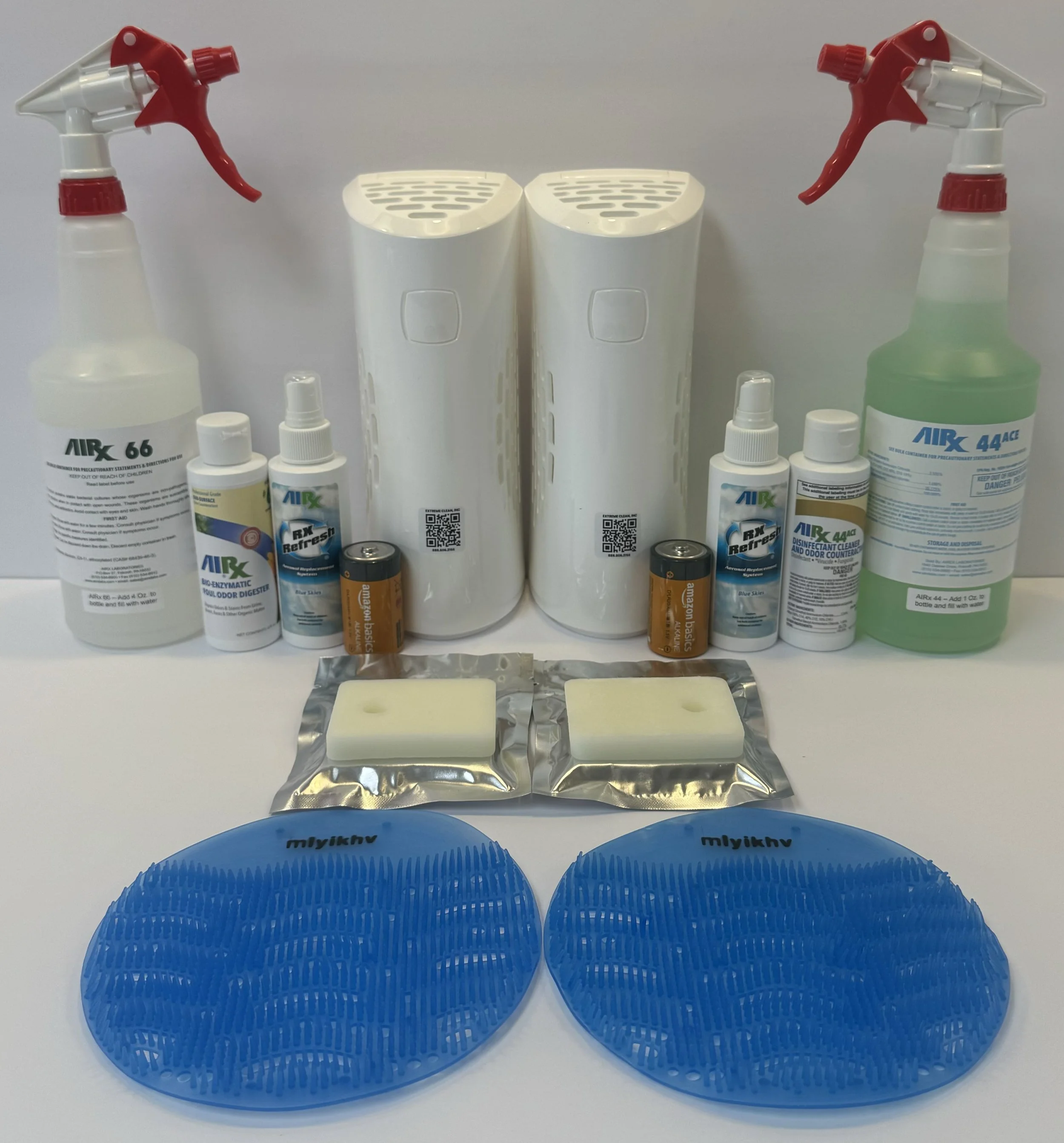 Cleaning supplies including spray bottles, disinfectant bottles, batteries, soap, and blue silicone scrubbers.