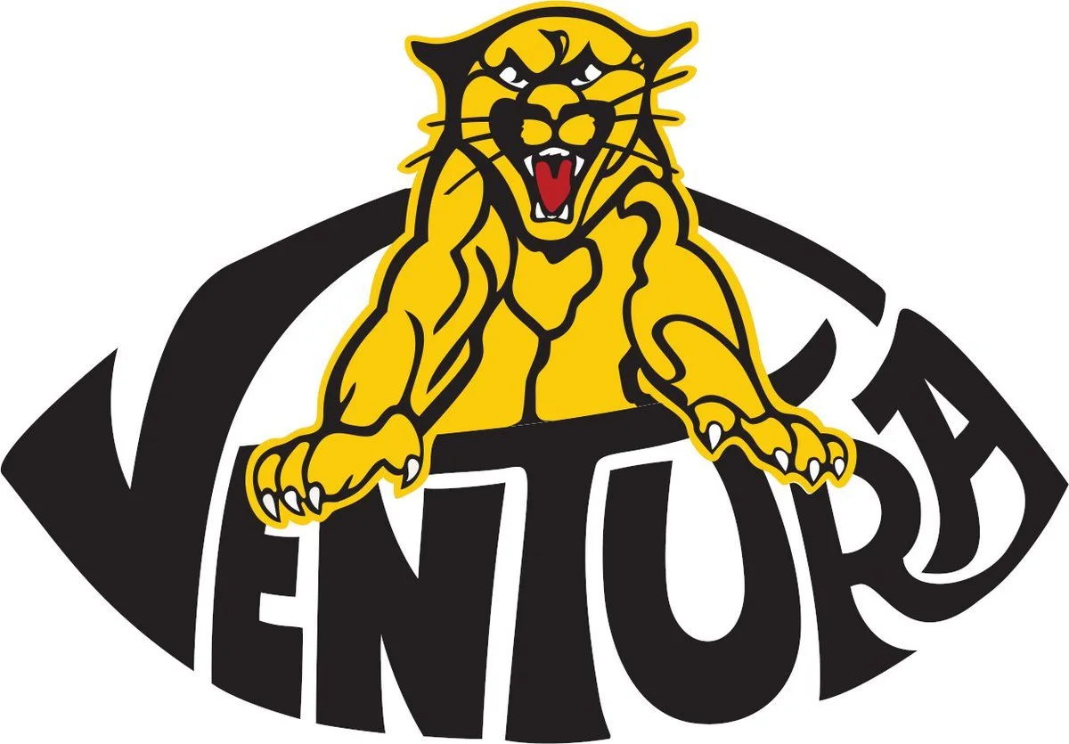 A cartoon tiger mascot with an open mouth and sharp teeth, leaning on the word "ENTOUR" in bold black letters, with a black and yellow color scheme.