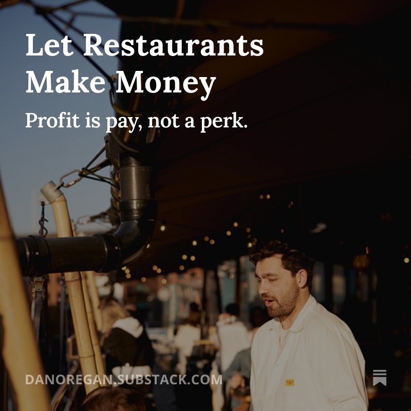 A man with dark hair and a beard, wearing a white shirt, appears to be in a restaurant or food truck setting. The background shows blurred people sitting at tables, and there are string lights overhead. The text on the image reads: "Let Restaurants Make Money. Profit is pay, not a perk."