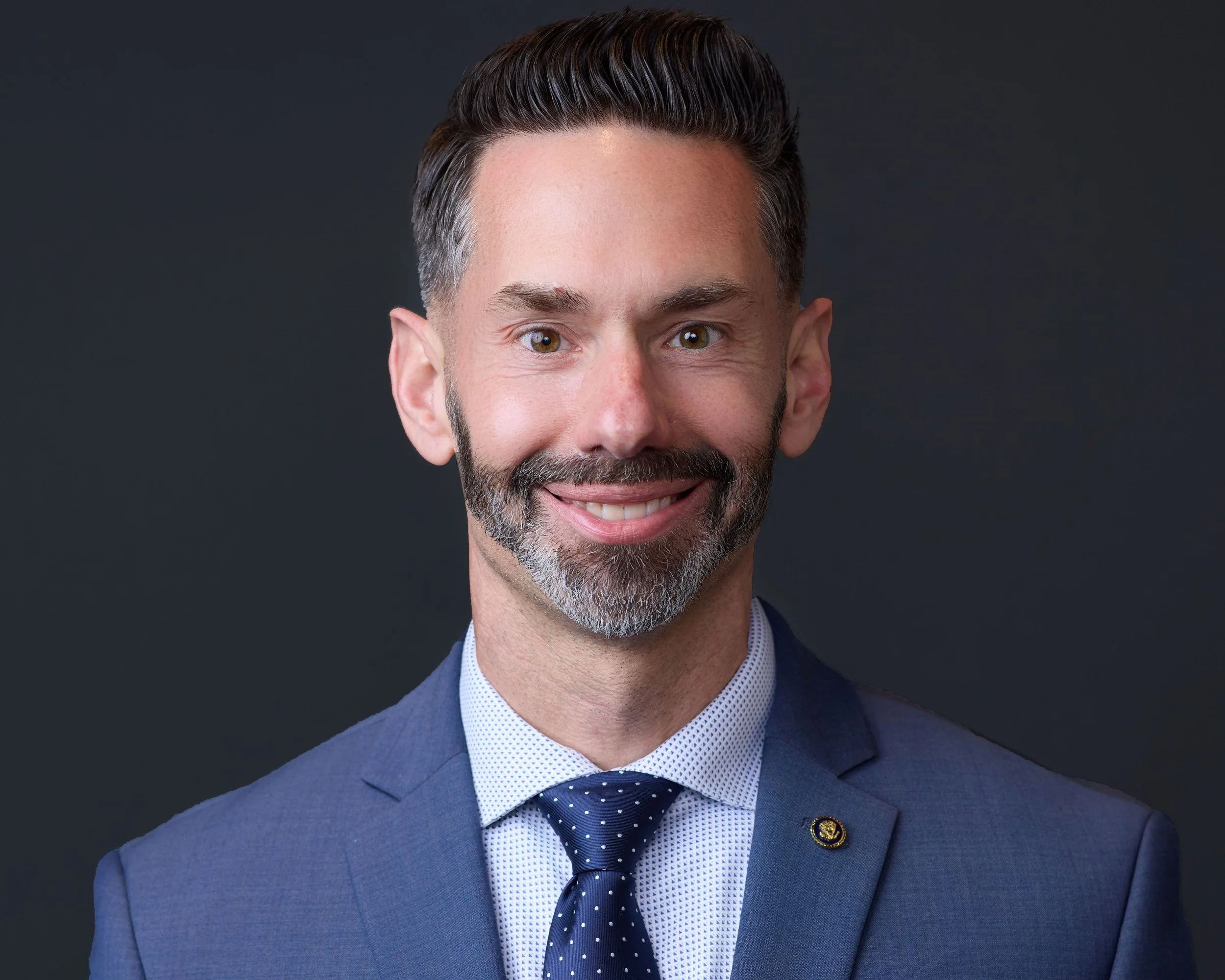 Professional headshot of a man wearing a blue suit and tie in my Clarksburg studio