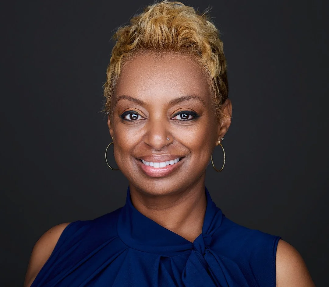 Headshot of a Clarksburg actress, wearing a blue dress