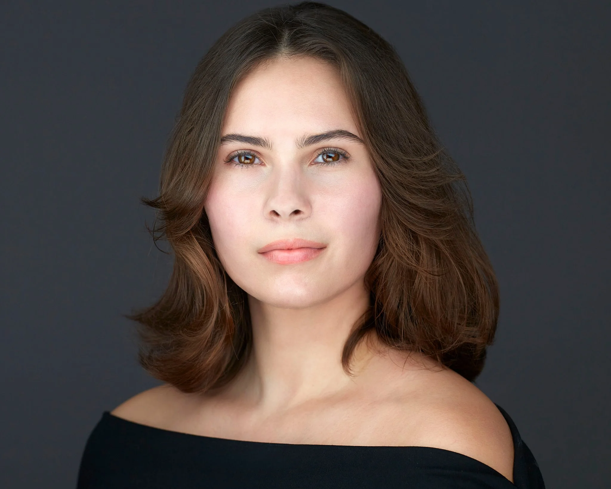 Clarksburg Acting headshot for a brunette female wearing a black sweater