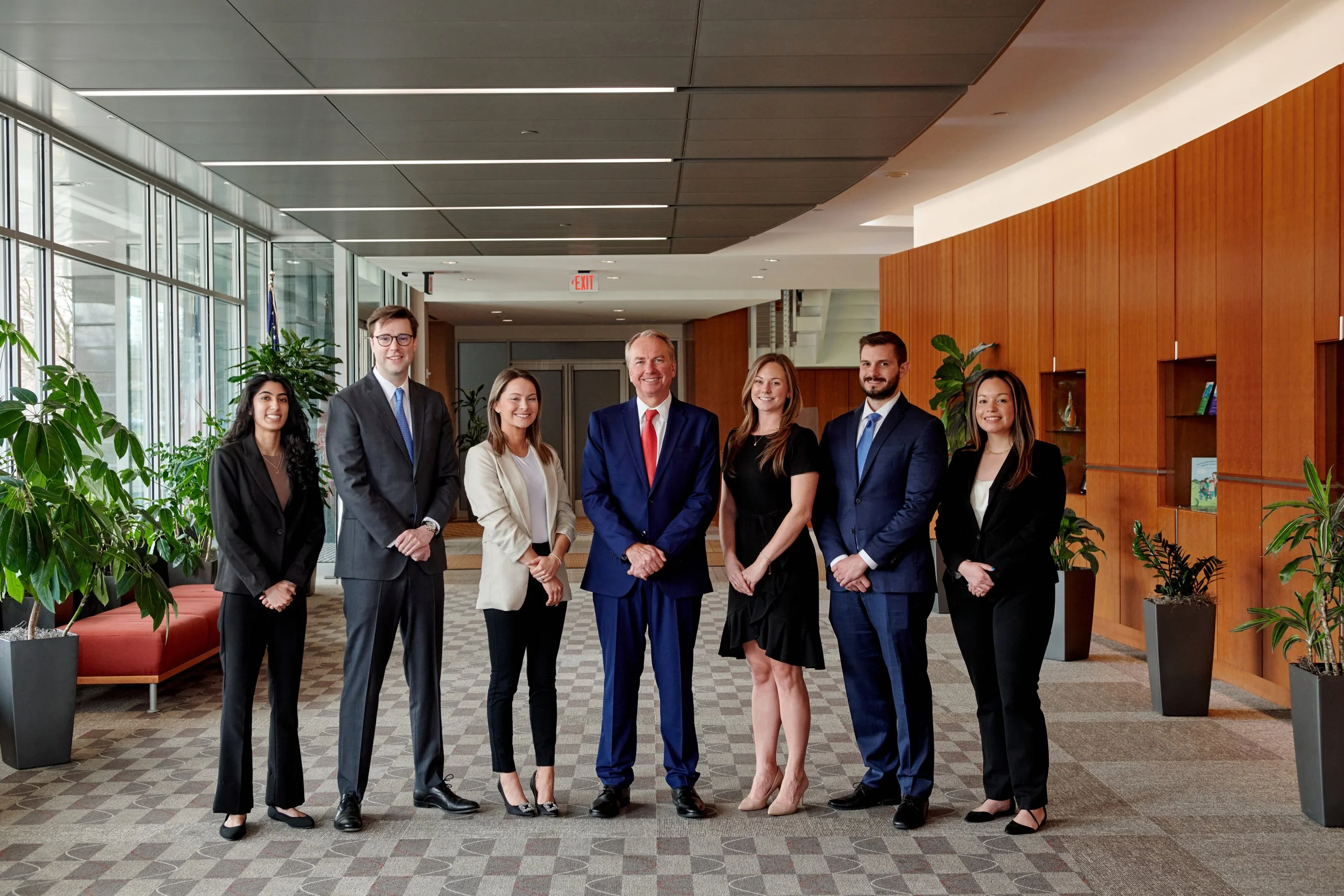 Team photo of the attorneys at McCarthy Wilson Law Firm taken in their office foyer.