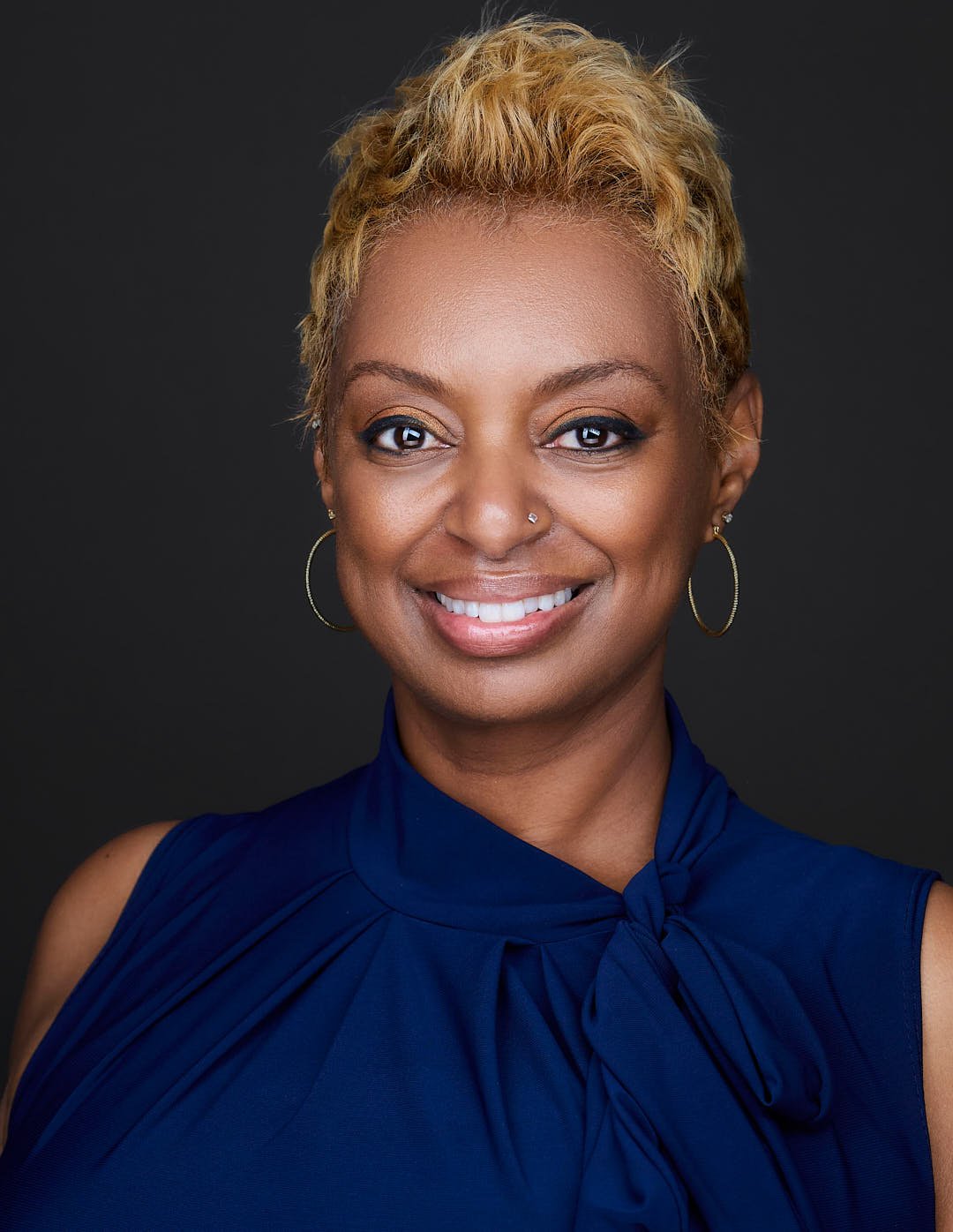 Headshot of a woman wearing a blue shirt for her linkedin profile