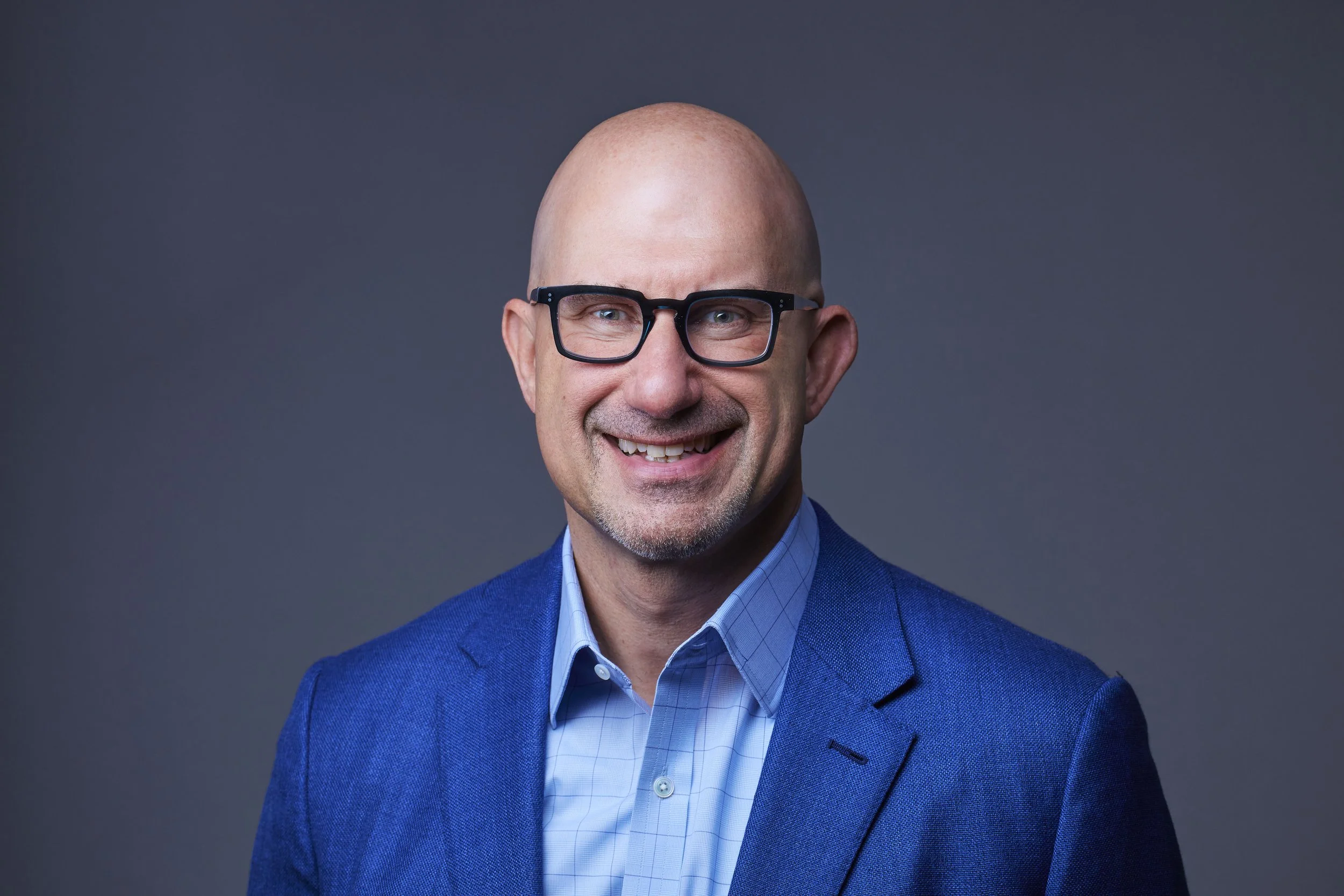 business headshot of a man in a blue sport coat