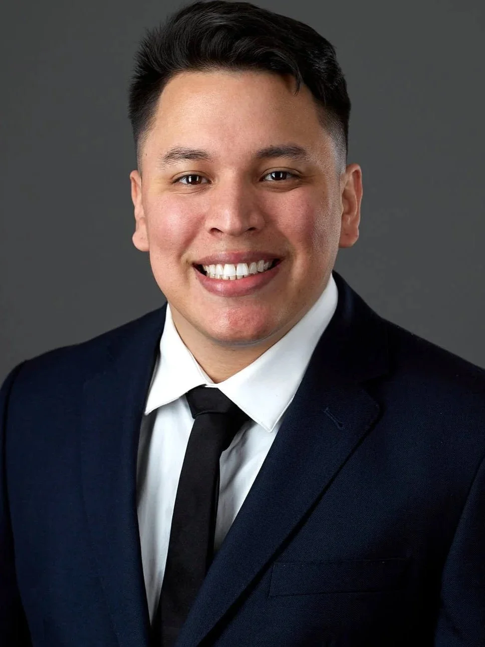 Headshot of a male real estate agent wearing a blue suit