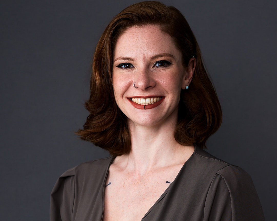 Business headshot of a female client wearing a grey dress