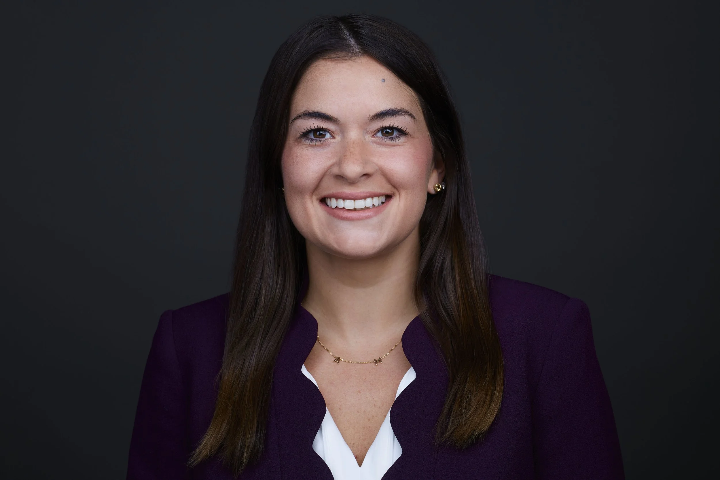 professional headshot of a female attorney wearing a purple blazer and white shirt.