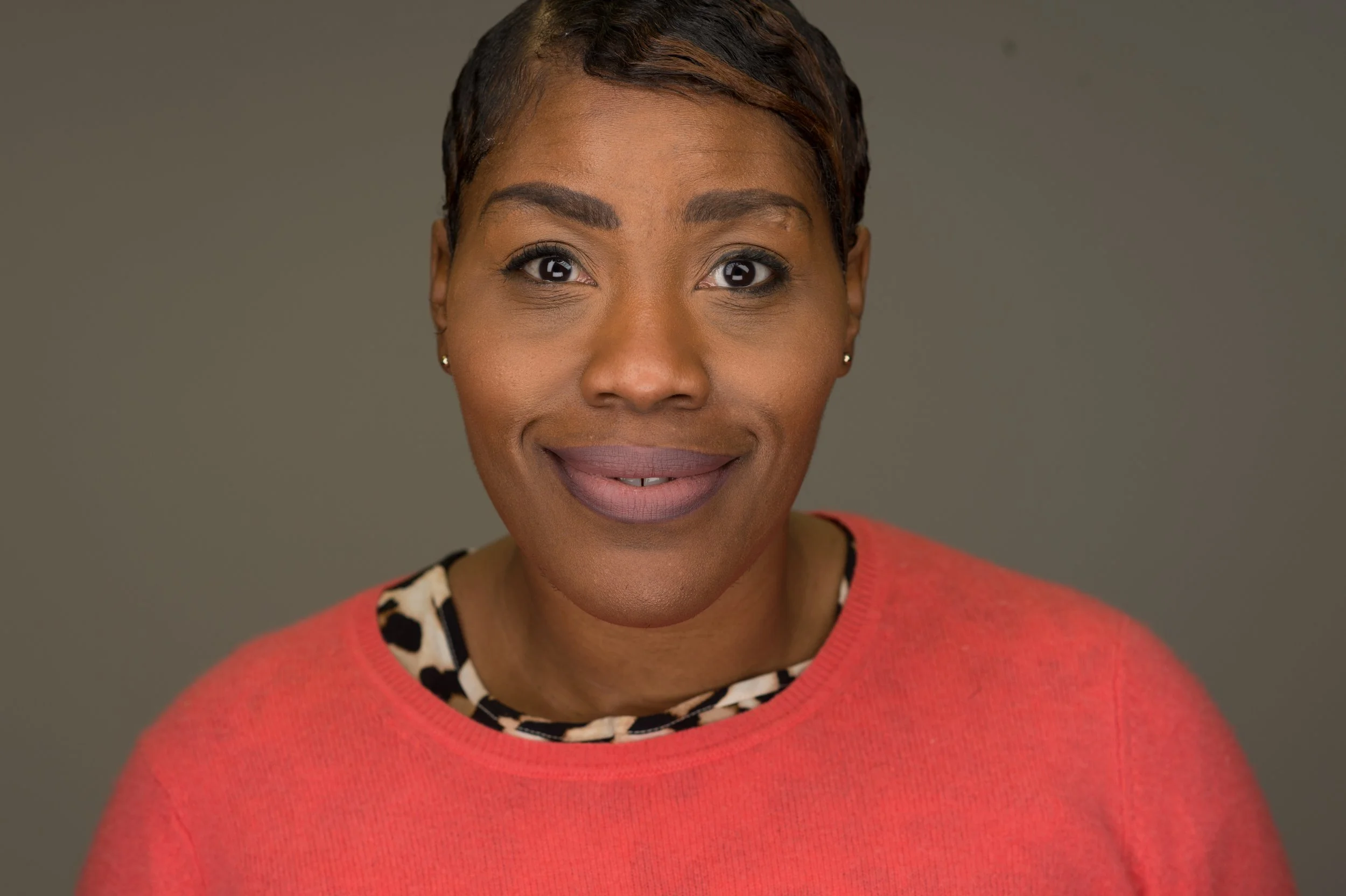 professional woman wearing a red sweater in her headshot