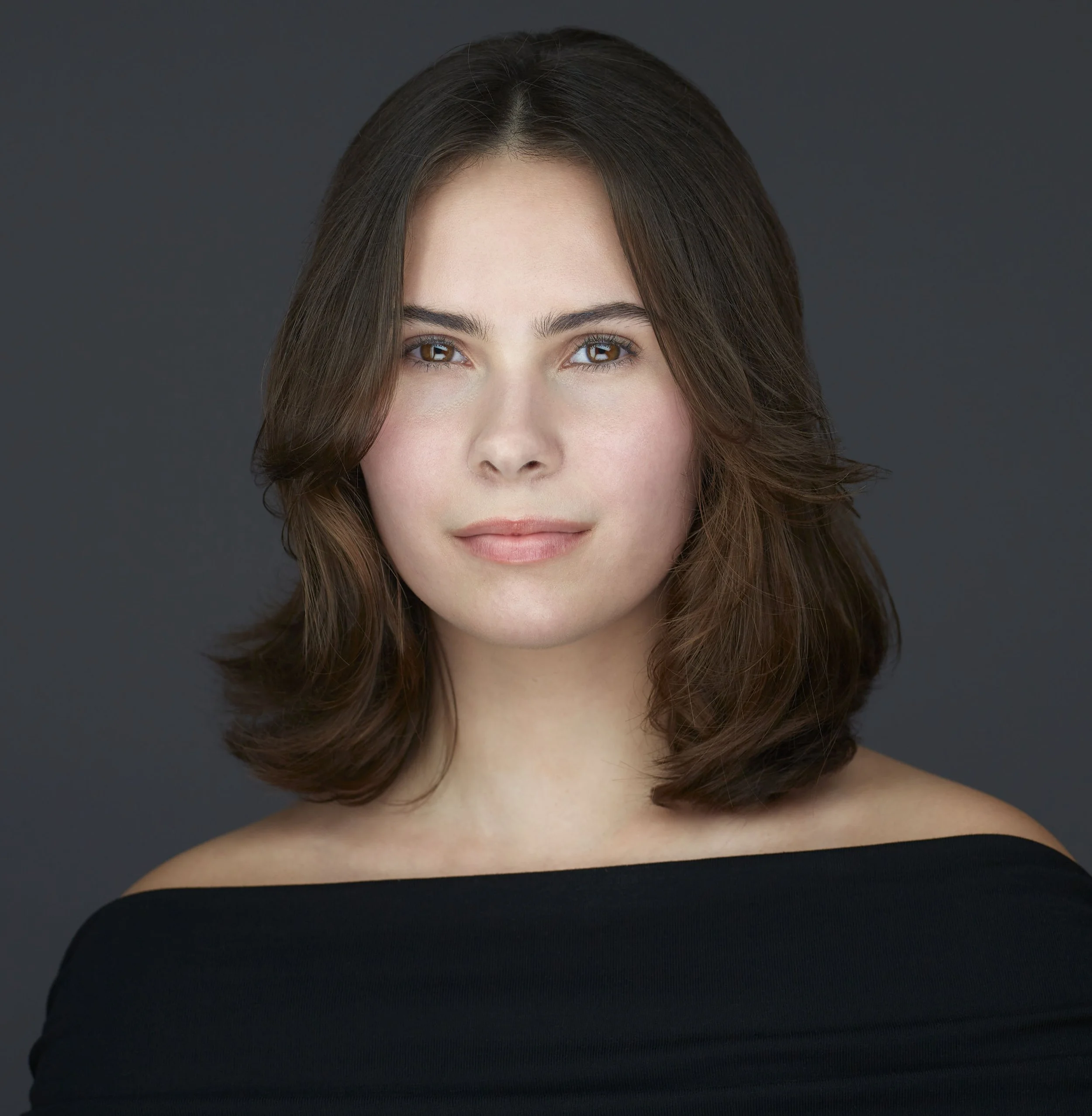 professional linkedin headshot of a woman wearing a black dress