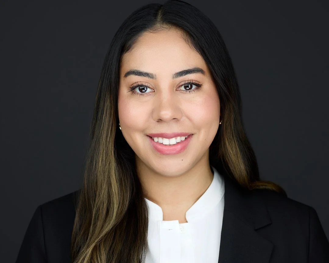 Linkedin headshot of a woman wearing a white shirt and black blazer