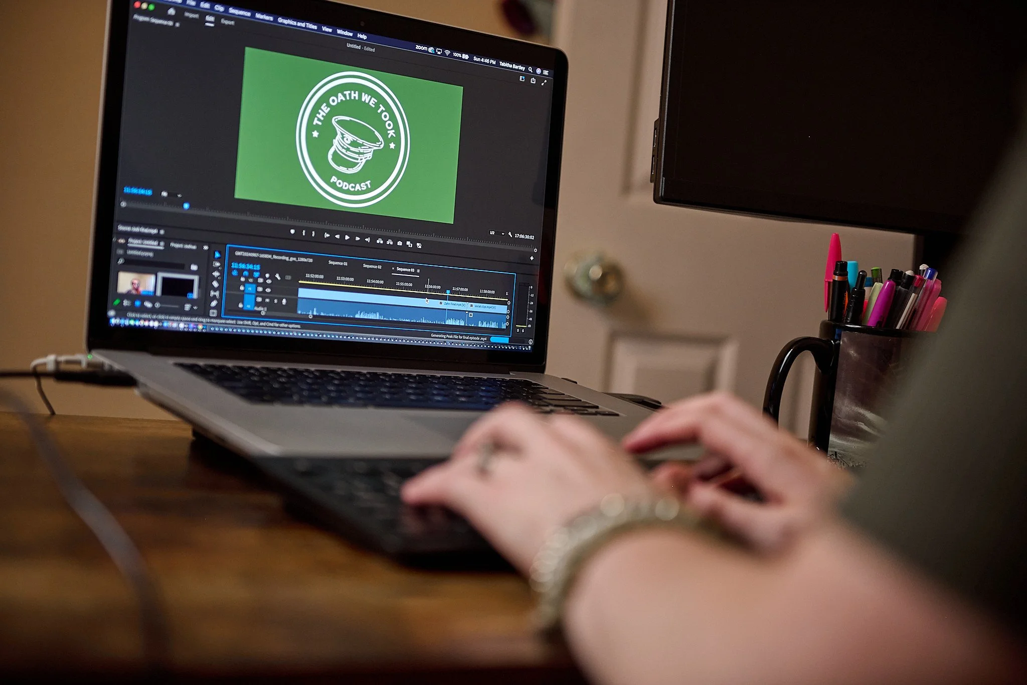 Personal branding portrait of a woman using a podcast station on her laptop