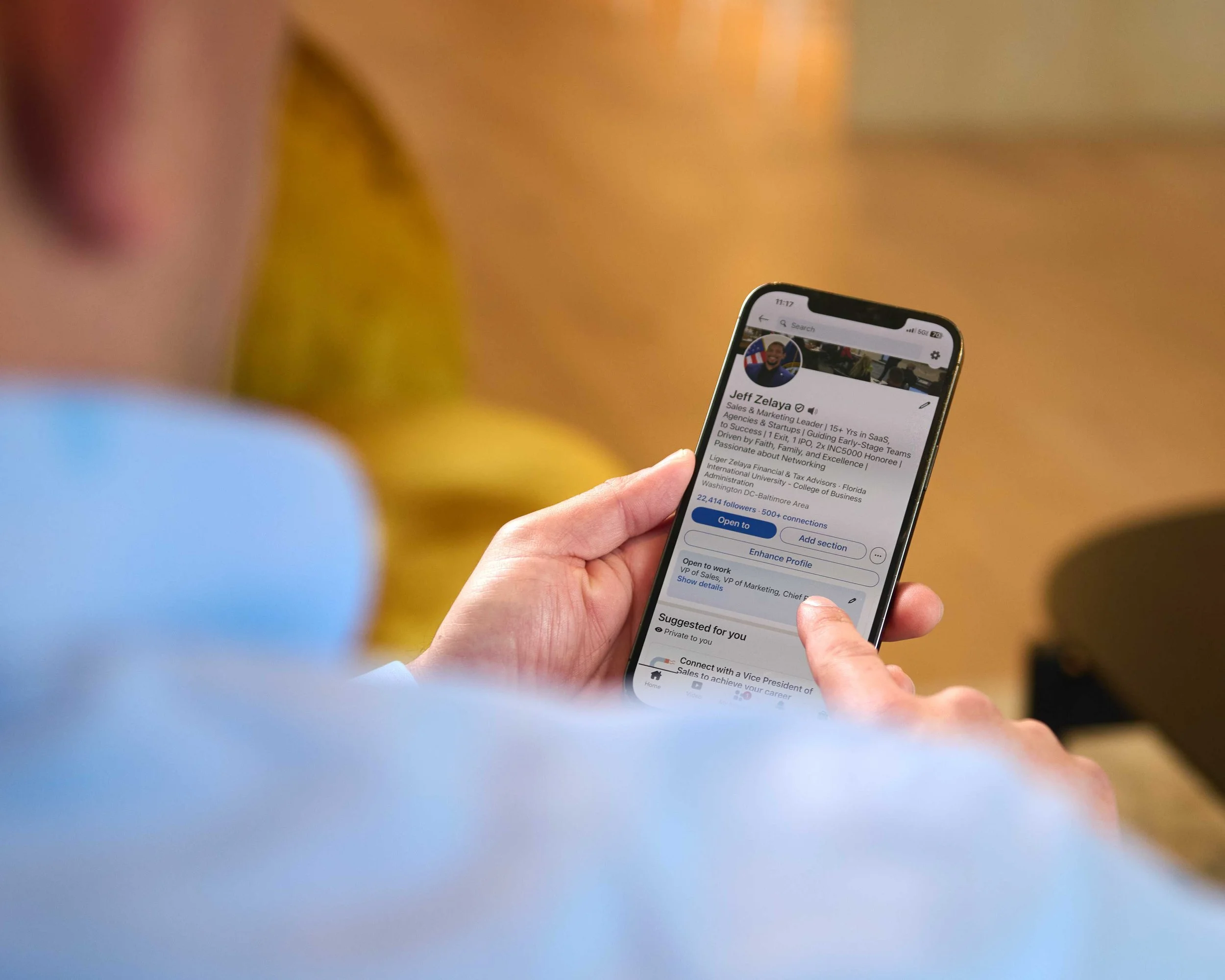 Branding portrait of a man using his phone to check Linkedin