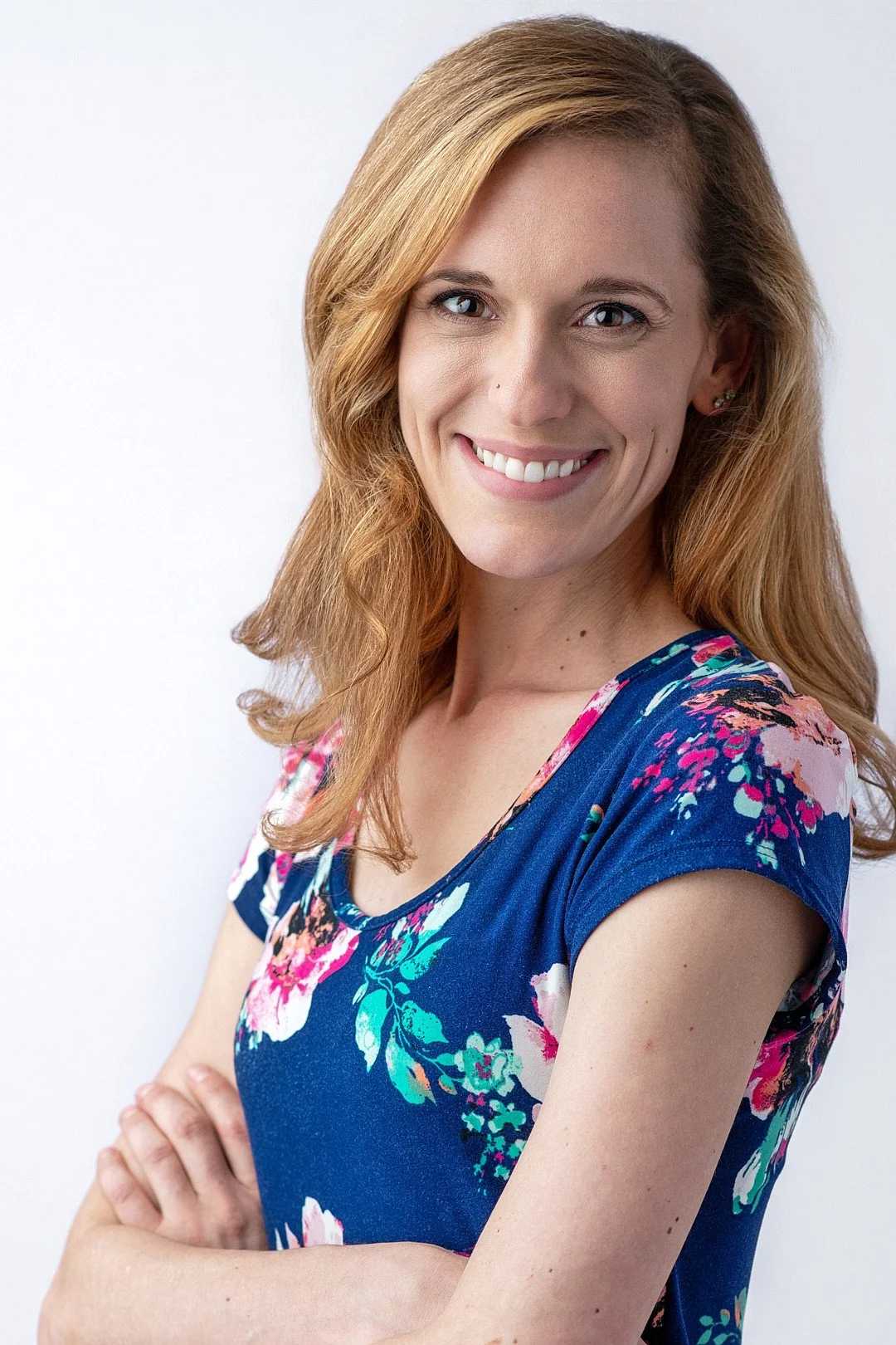 acting headshot of a woman wearing a blue flowered dress