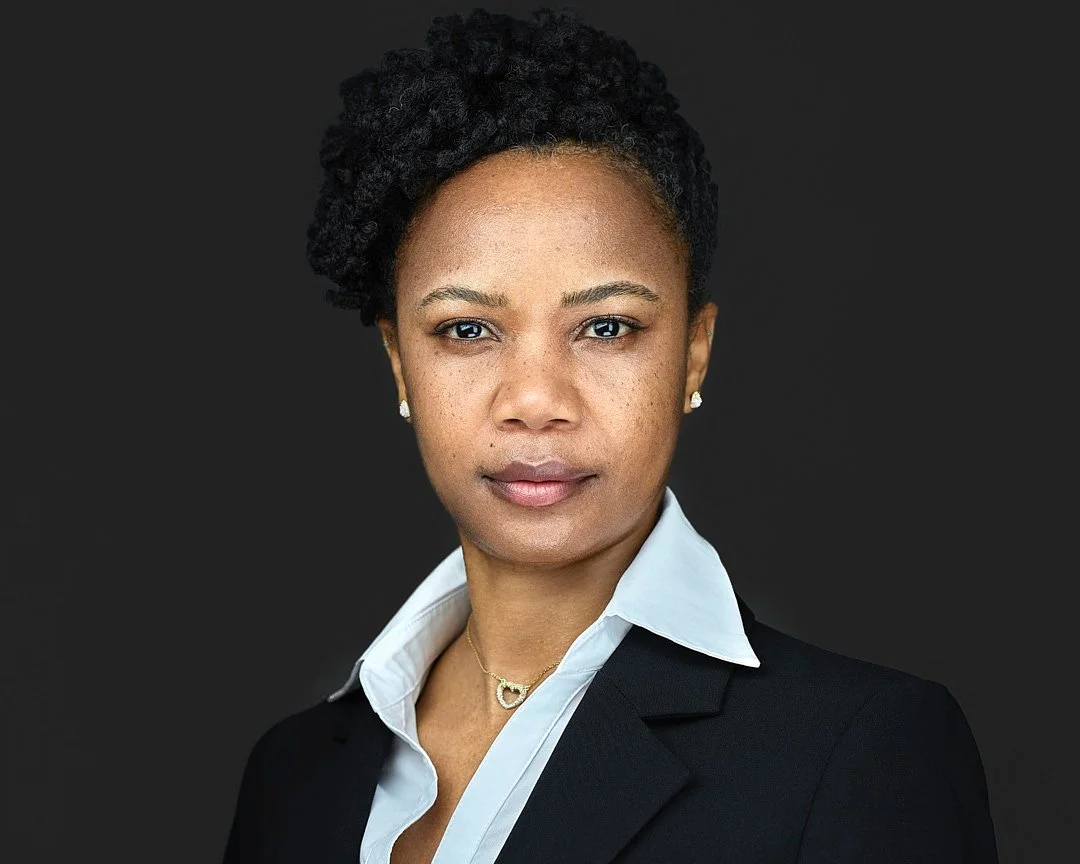 GovCon headshot of a woman wearing a white shirt and black blazer