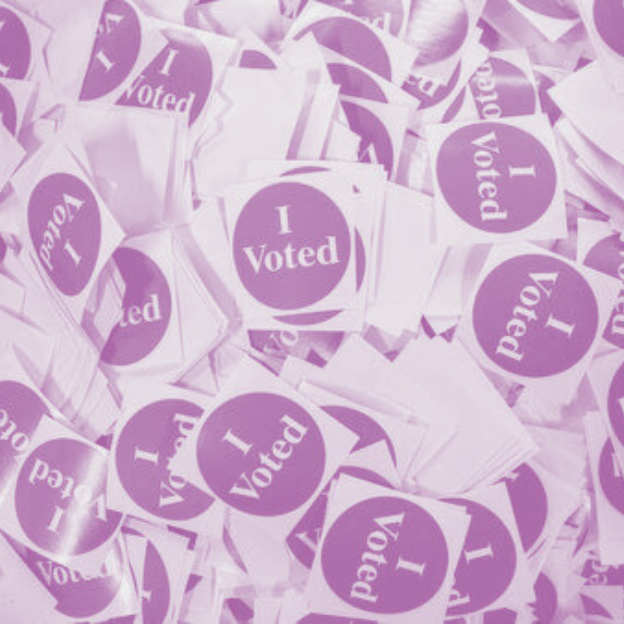 A large pile of purple and white 'I Voted' stickers.