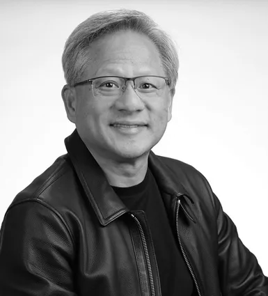 Black and white portrait of an older man with glasses, short gray hair, wearing a leather jacket, smiling at the camera.