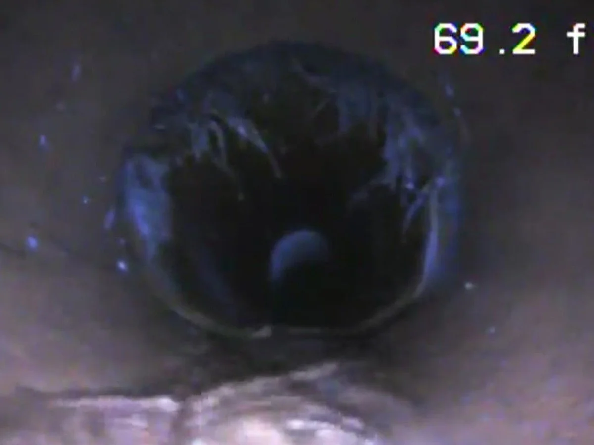 Sewer camera view showing a connection inside a residential sewer line.