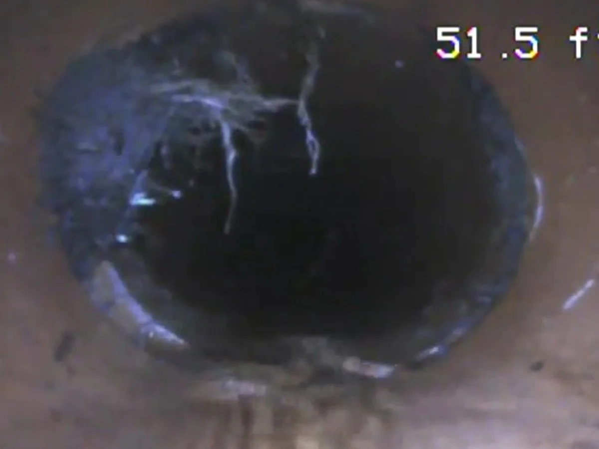 Sewer camera view of a pipe opening during a residential sewer line inspection.
