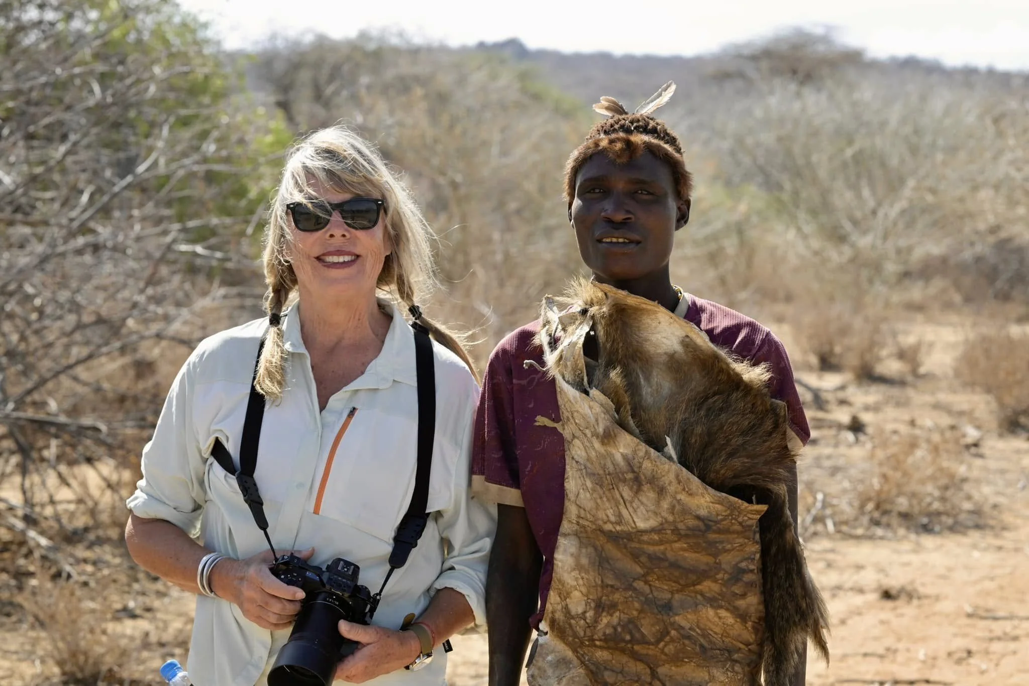 Caravan Gallery Owner Linda next to Yabashi, a Hadzbe Hunter in Tanzania