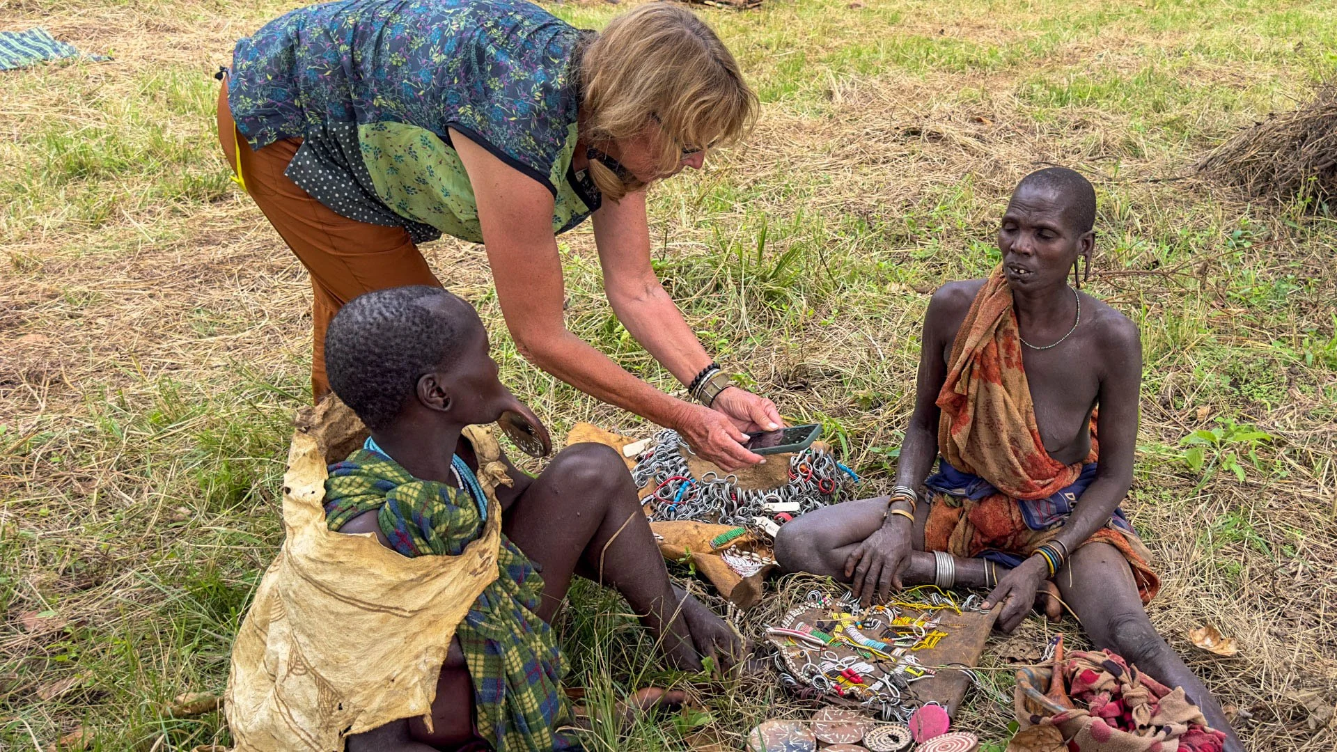 Caravan Gallery in La Conner, WA - Owner Linda purchasing clay lip plates from the Suri Tribe in Tanzania. Available for purchase 