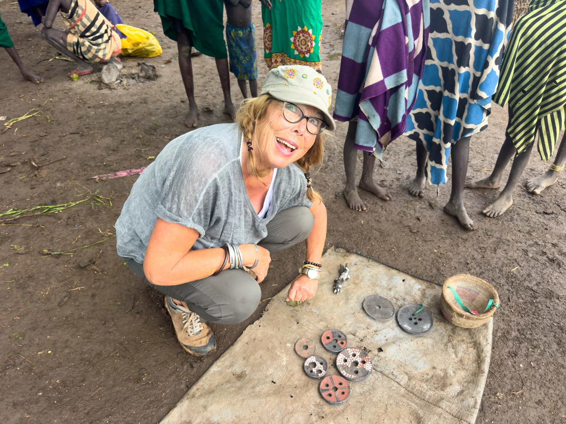 Caravan Gallery in La Conner, WA - Owner Linda looking at clay lip plates made by the Suri tribe in Ethiopia in the Omo valley. 