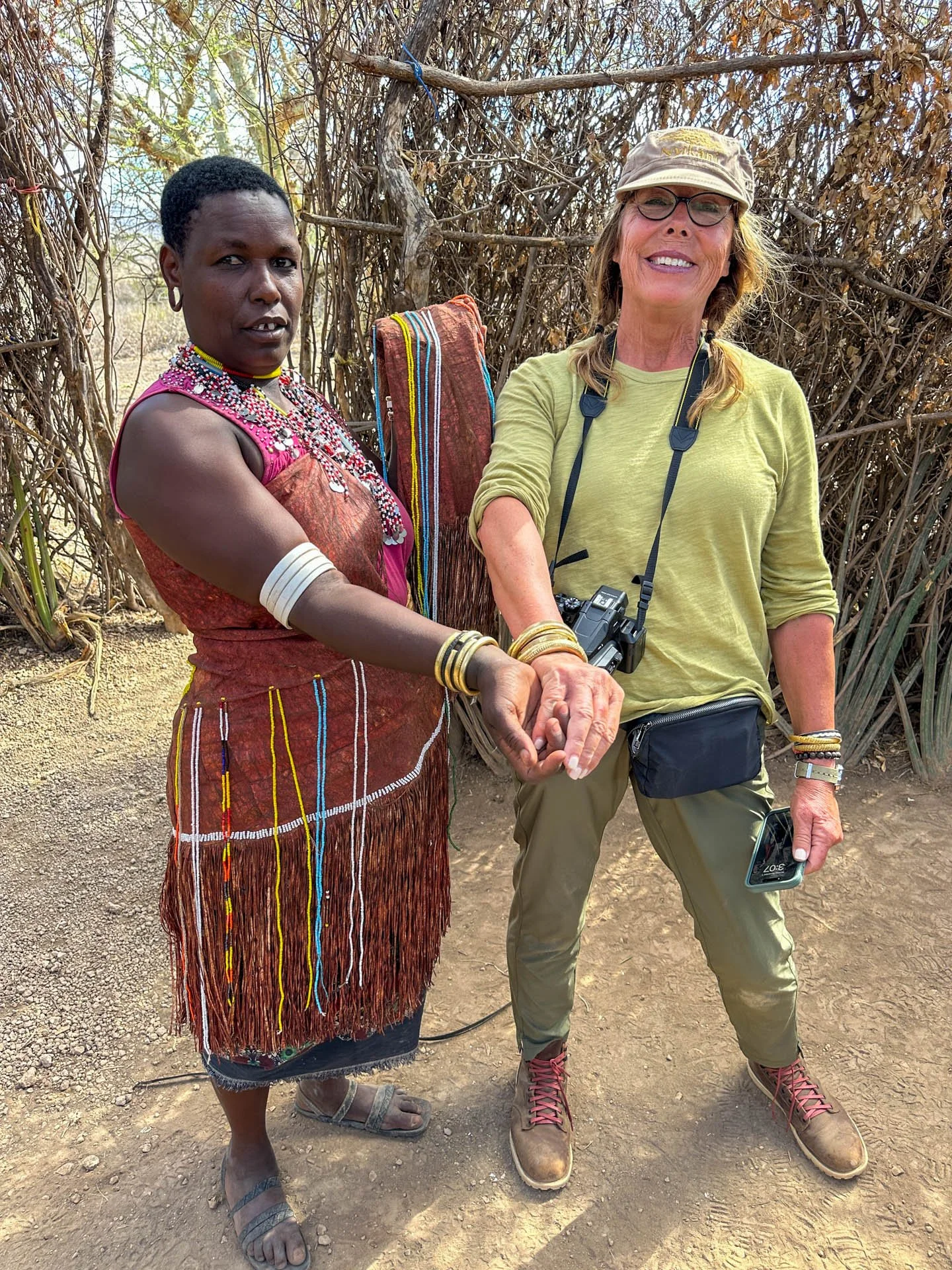 Caravan Gallery in La Conner, WA - Owner Linda Banaszak with a Dakoga wife in Tanzania, while shopping for bracelets. 