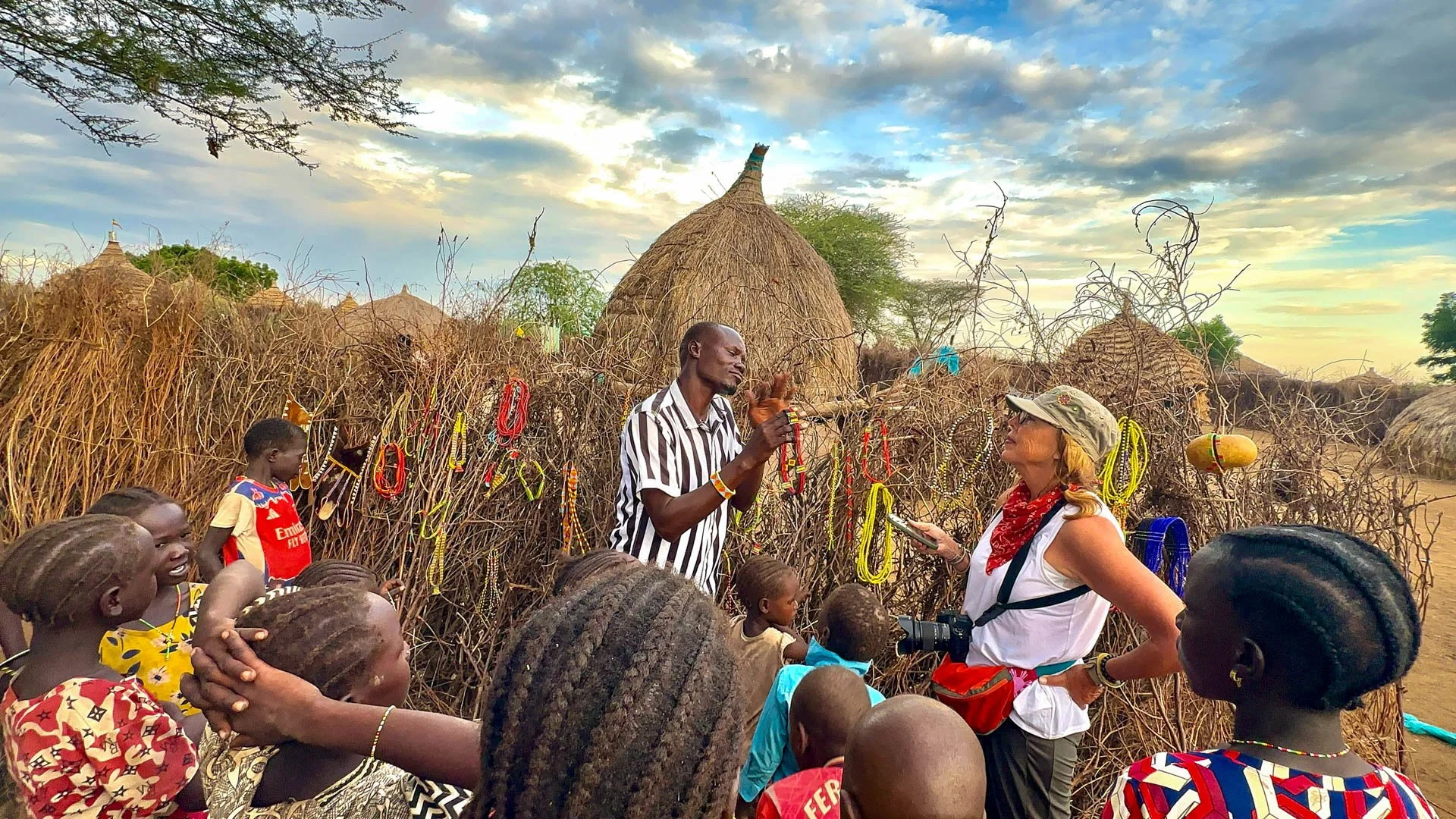 Caravan Gallery in La Conner, WA - Owner Linda negotiating inside a small Nyangatom village in Ethiopia to purchase products for her store. 