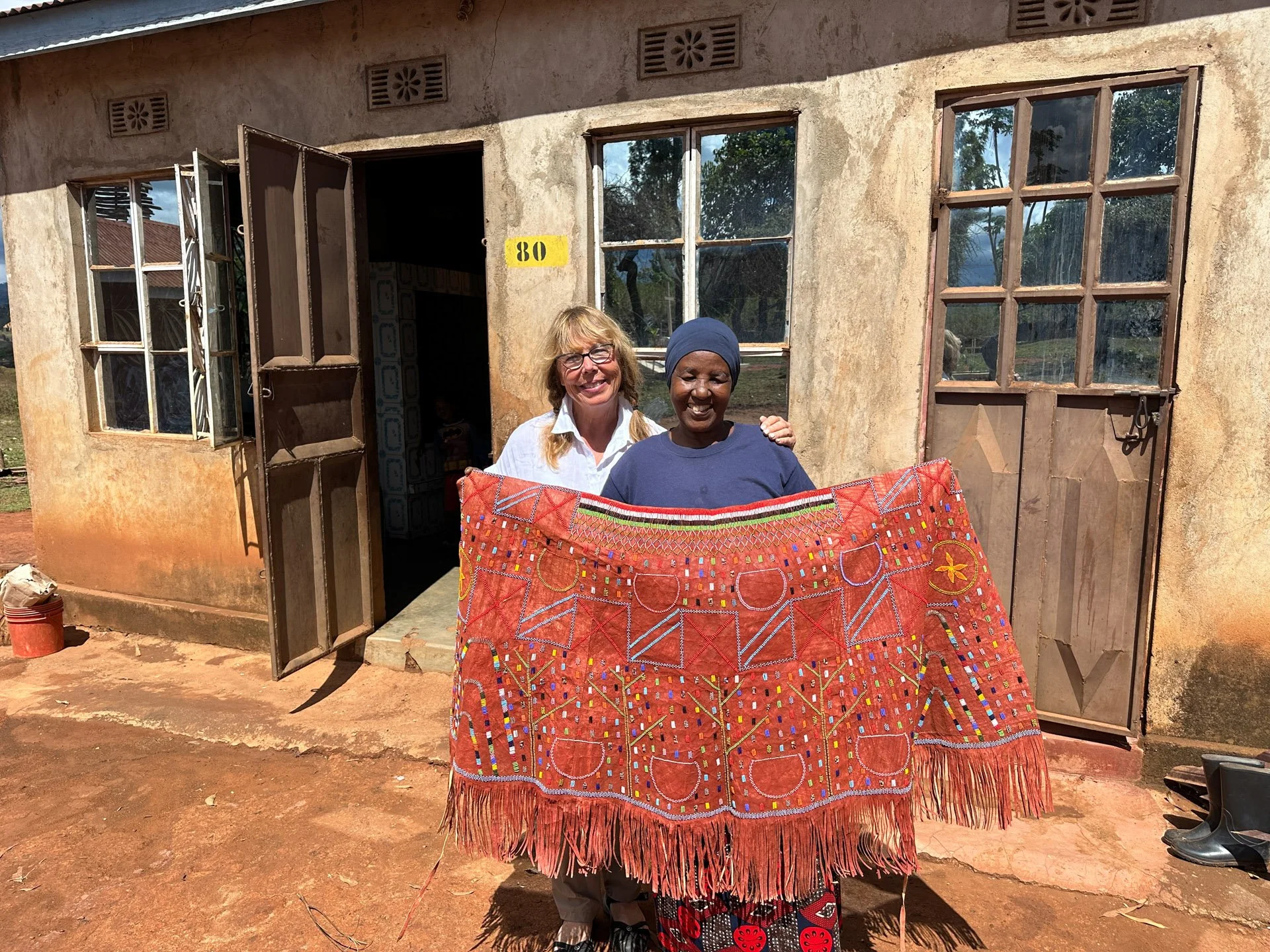 Caravan Gallery in La Conner, WA - Owner Linda with a traditional Iraqw wedding skirt fashioned by Elizabeth in Karatu, Tanzania. 