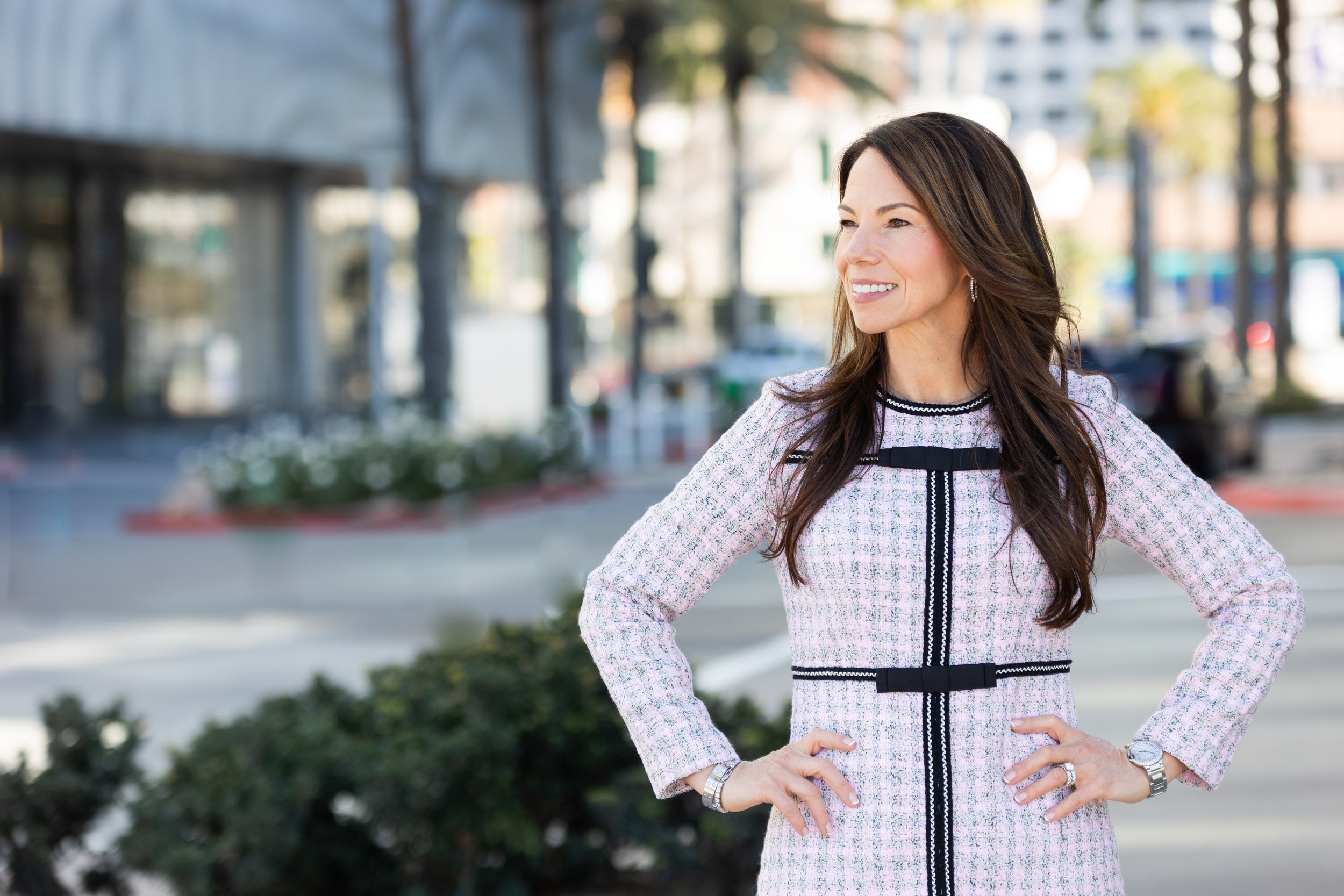 Tina Moore, standing in a power pose, offering guidance, support, love, and encouragement through alcohol recovery by creating spaces, tools, and rituals for other women.