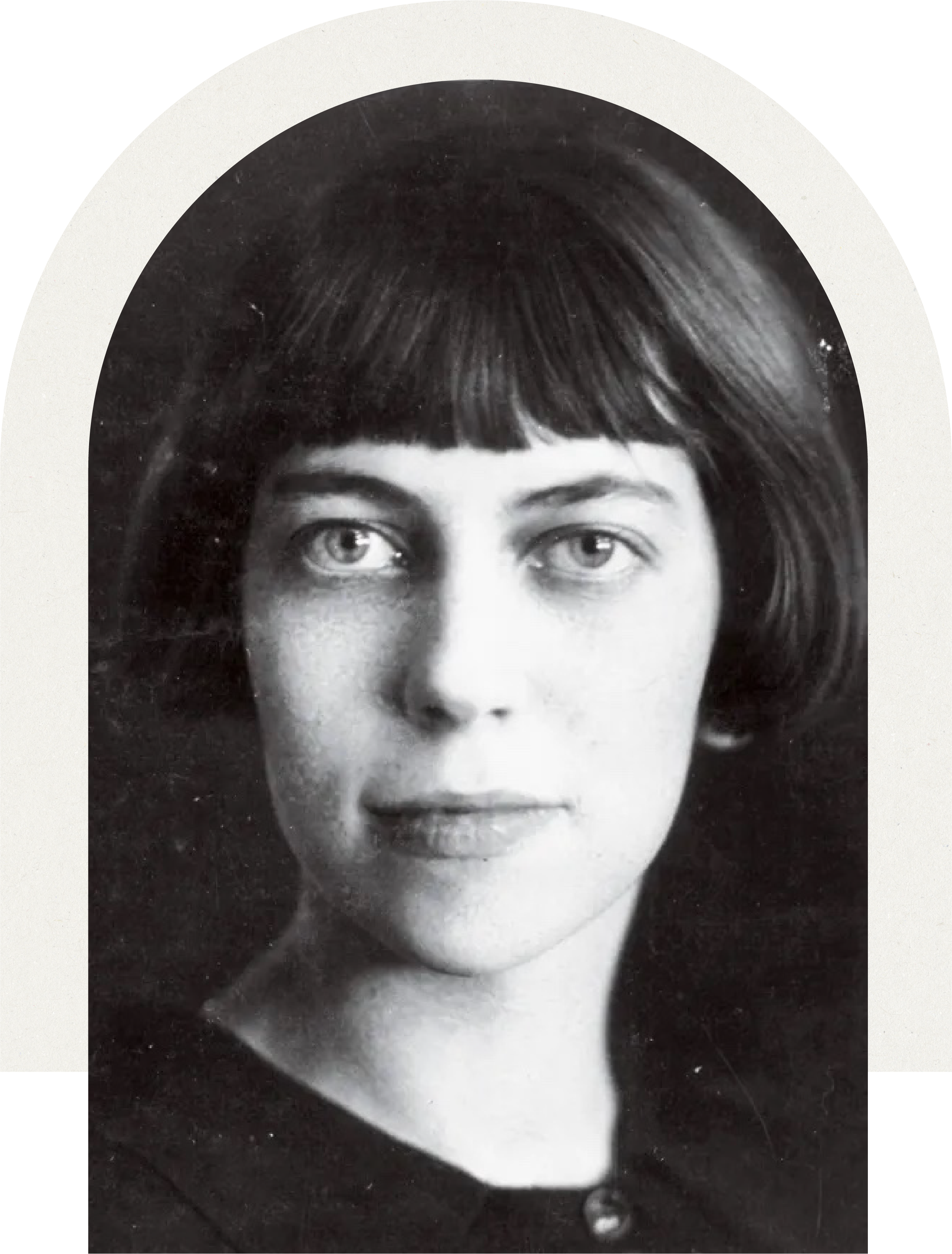 A black and white portrait of young Eudora Welty with short dark hair and bangs, looking directly at the camera.