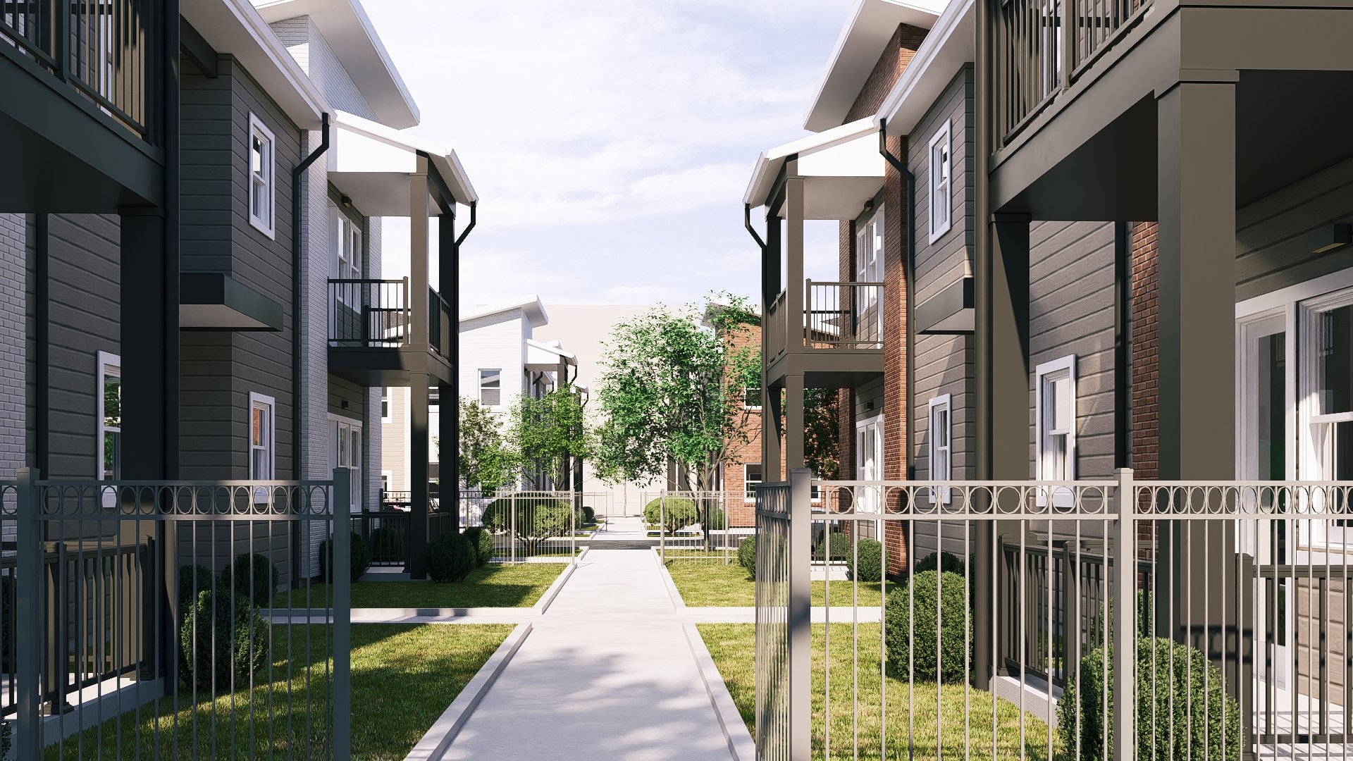 A view of a modern residential apartment complex with a paved walkway, fenced yards, and trees between buildings with balconies.