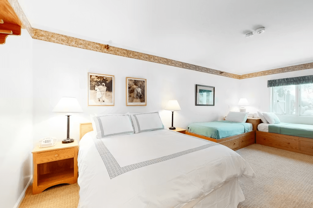 Guest bedroom has a queen bed and two twin beds