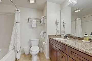 The second bathroom has dual sinks and plenty of storage
