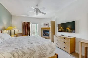 The Master Bedroom has a gas fireplace, a private porch and a smart TV