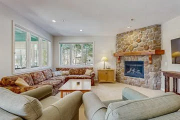 Spacious living room with gas fireplace, smart TV and plenty of seating. The couch folds out for additional guests.