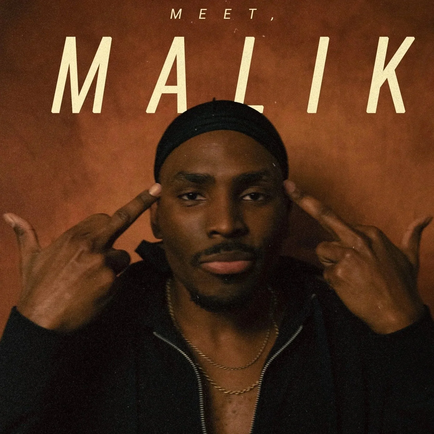 A man with dark skin, mustache, and goatee posing with his hands near his head, pointing at his temples, in front of a brown background with the words 'Meet, Malik' in large letters at the top.