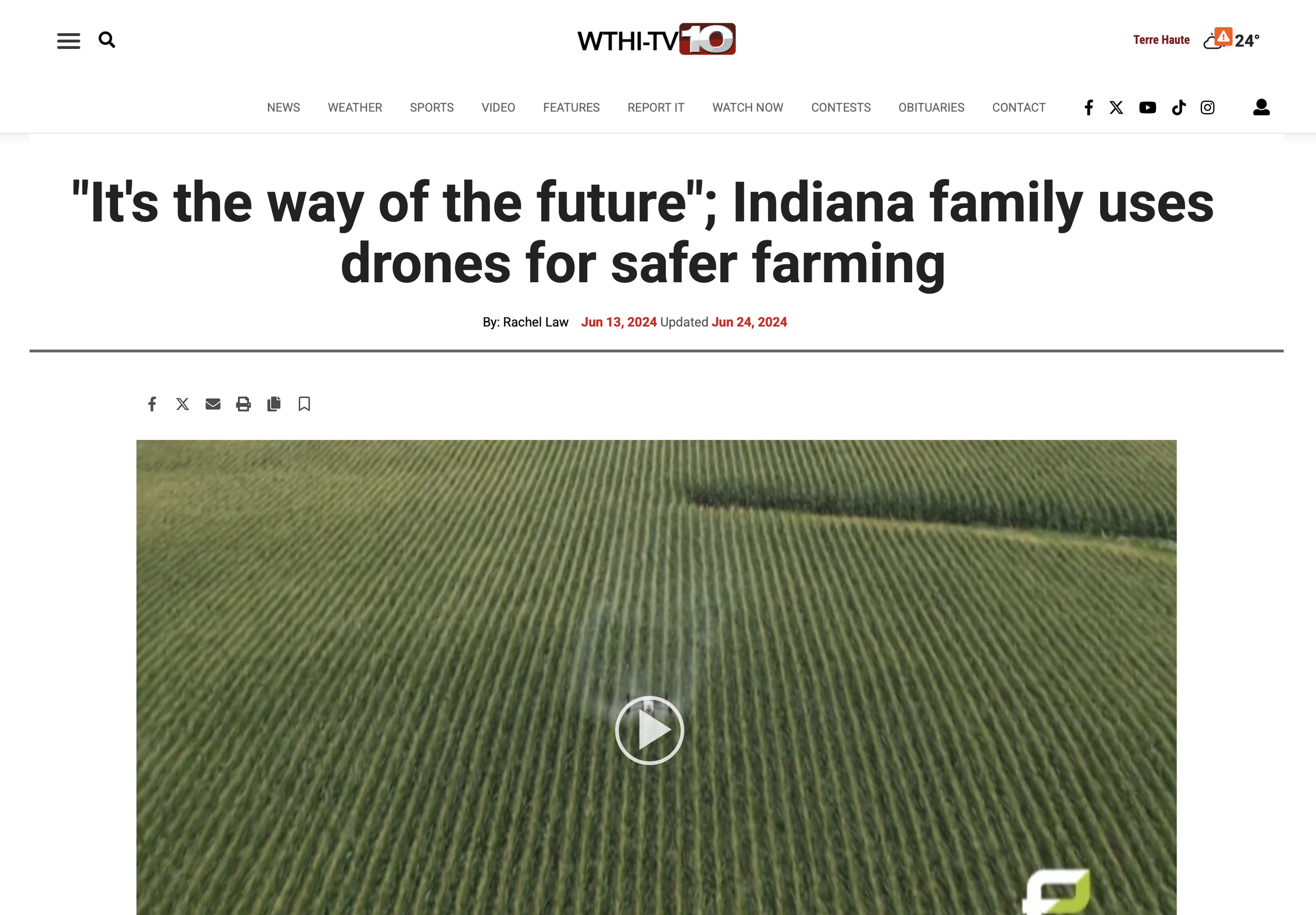 A large agricultural field with rows of crops, viewed aerially, with a play button overlay suggesting a video.