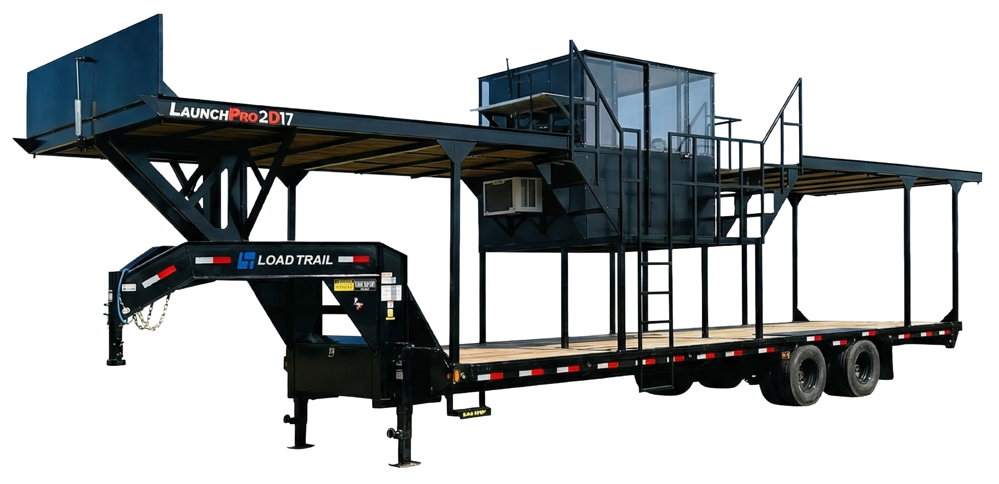 A large black mobile stage trailer with two levels, street tires, and a ladder leading to a second-floor platform. It has a black metal frame, with a glass-enclosed control room or viewing area on the second floor. The trailer has branding that reads "LOAD TRAIL" and includes an extendable ramp or platform at the front.