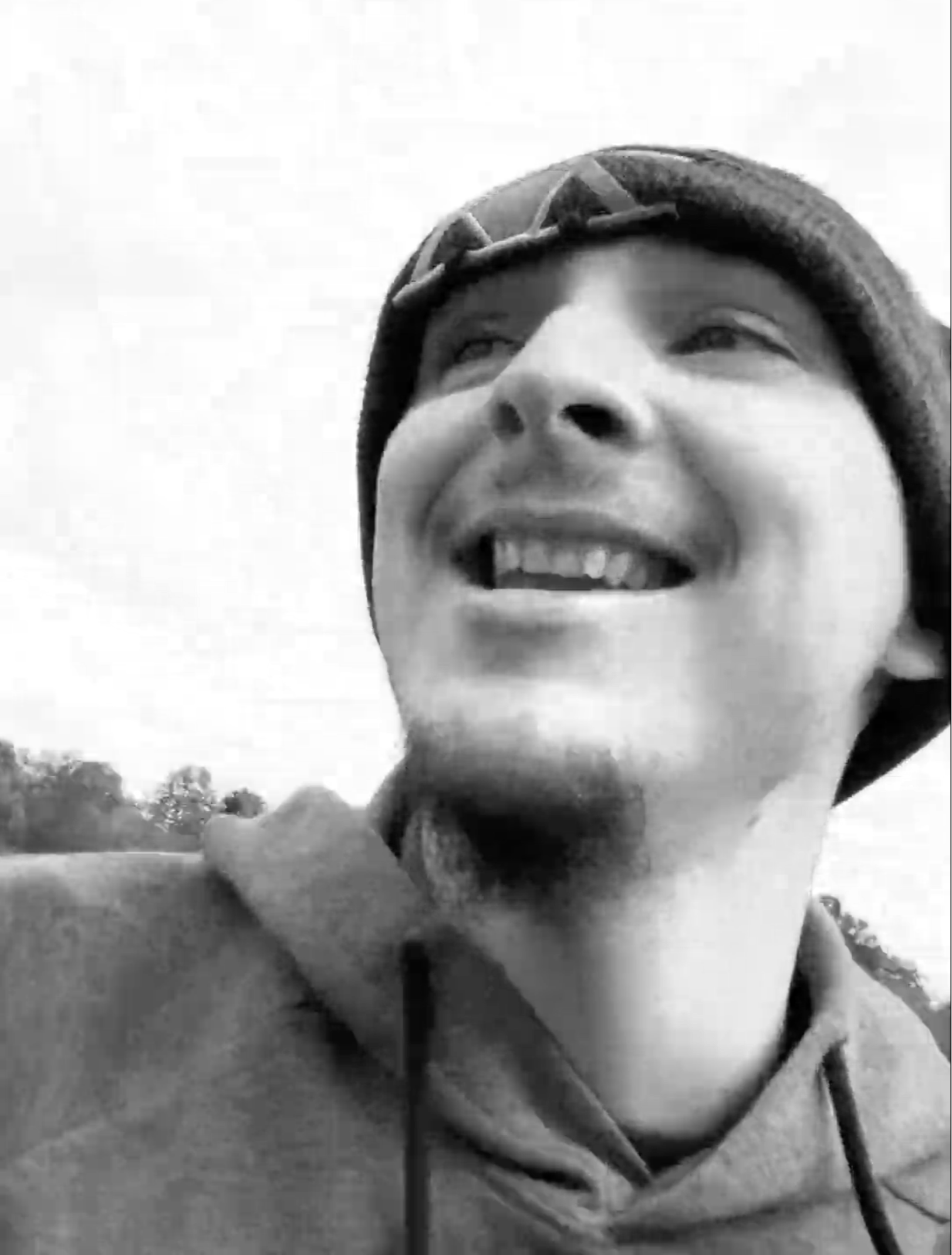 AVRY smiling over his shoulder with hat on