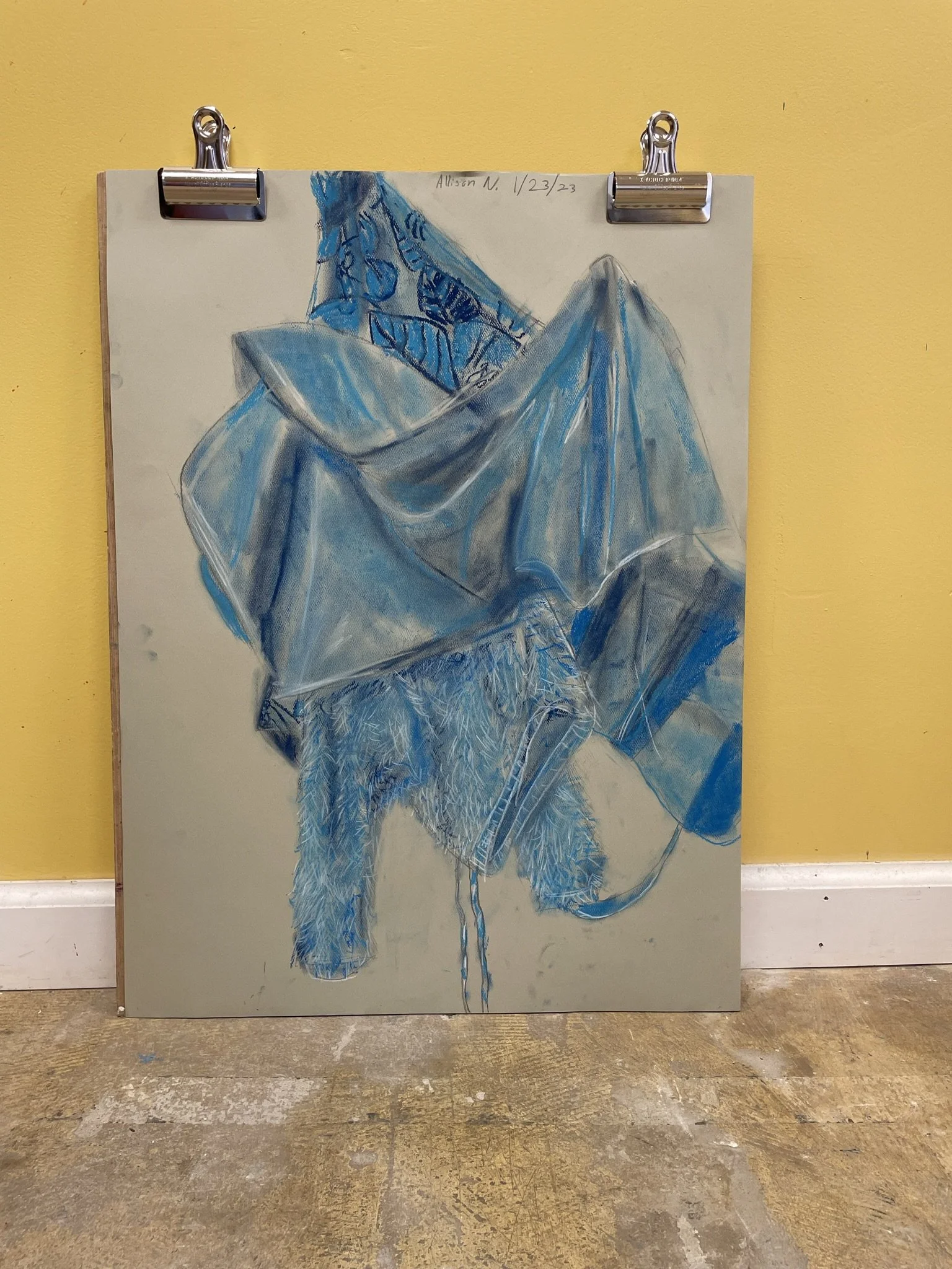 A detailed drawing of a pile of clothes, including a blanket, a hat, a towel, and a fluffy garment, rendered in shades of blue on a beige background, signed and dated at the top.