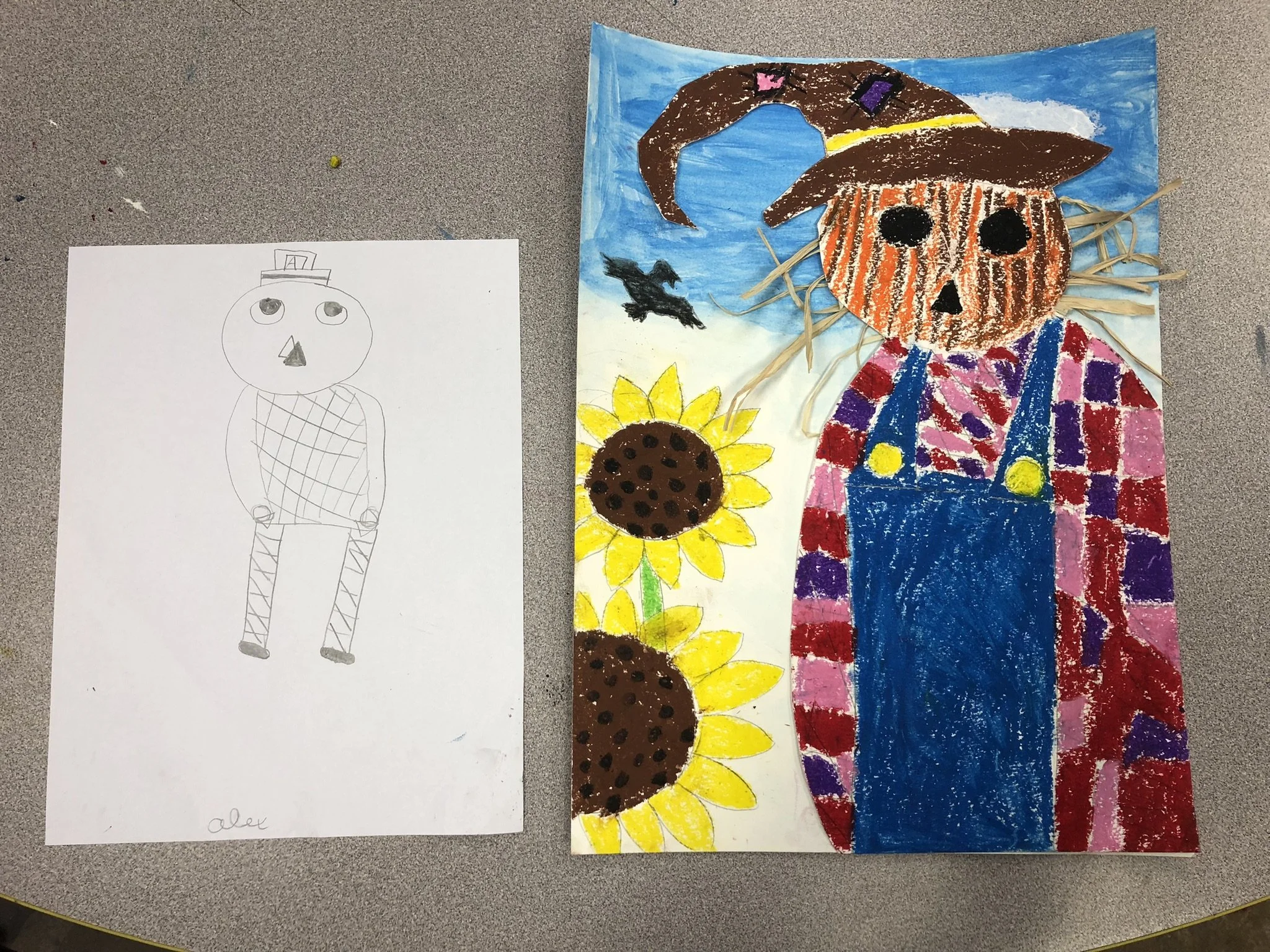 Colorful child's drawing of a scarecrow with a pumpkin head, wearing a witch hat, plaid shirt, and overalls, standing next to sunflowers on a painted background with blue sky and flying bats.