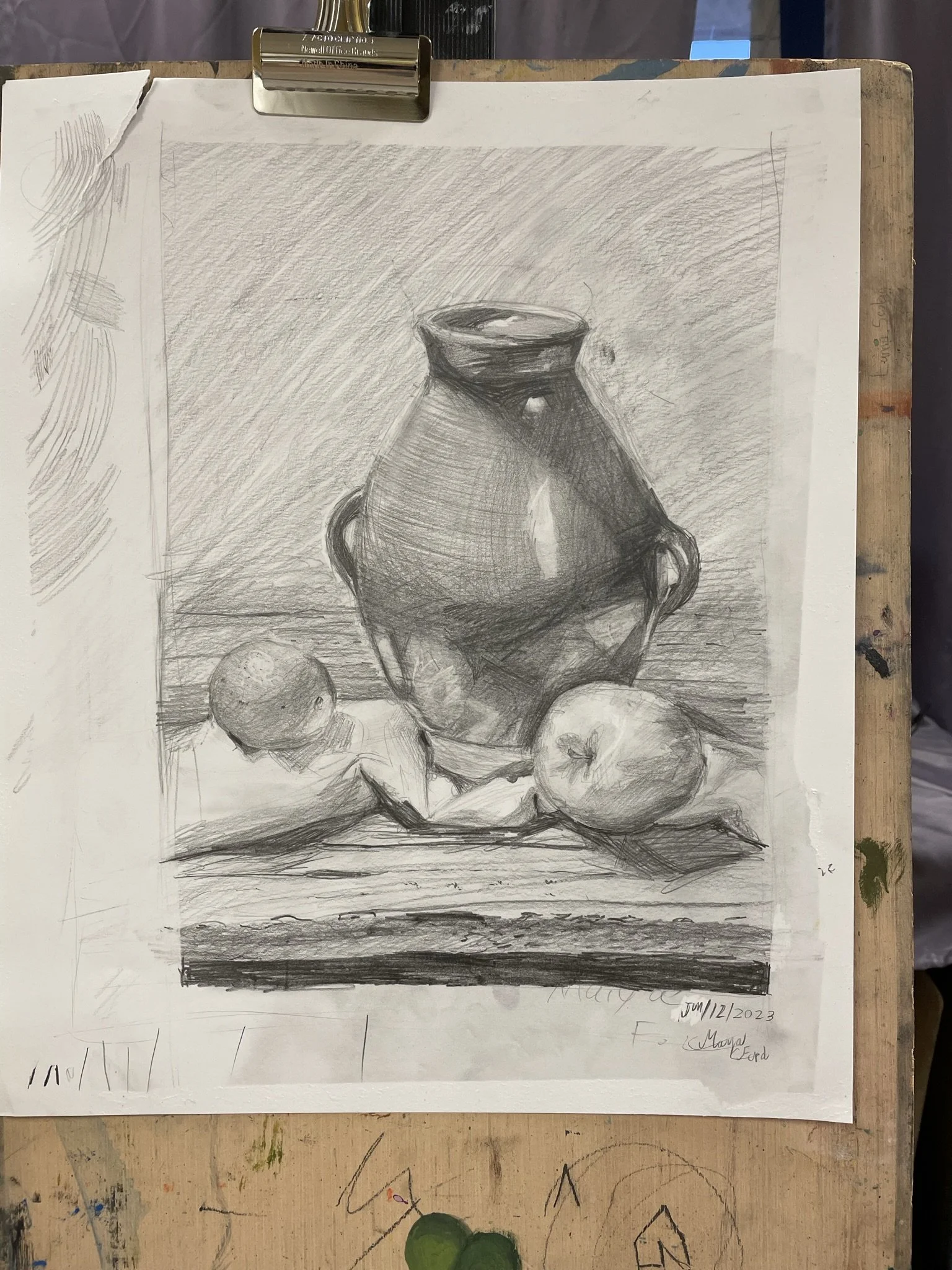 A detailed grayscale still life sketch of a large ceramic vase with two small handles on either side, placed on a flat surface. To the left of the vase, there is a small round object, possibly an apple or a peach, and a significantly larger apple or 